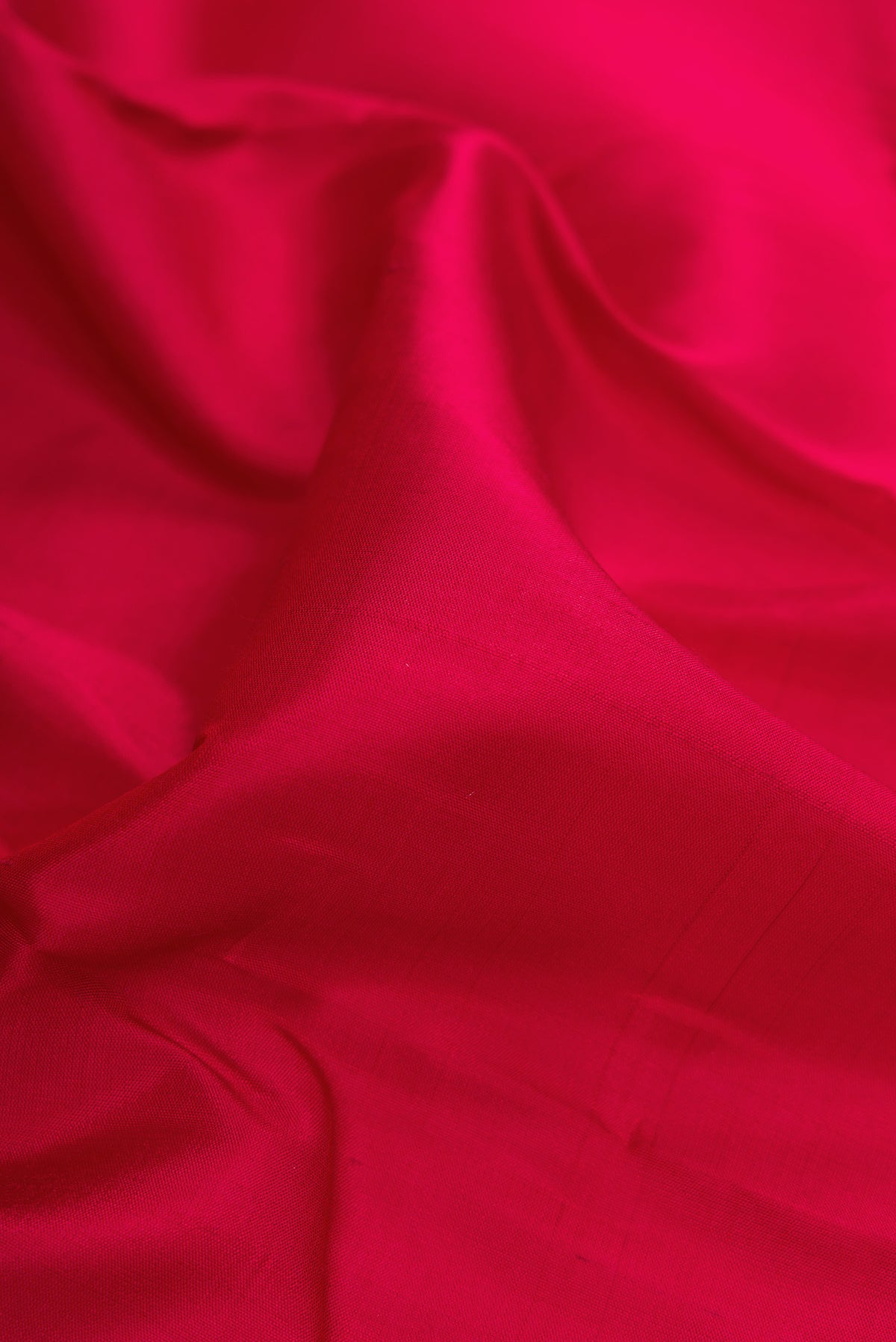 Close up of Maroon Dual Tone Kanchipuram Silk Saree with Plain Body and Zari Border.  displaying folds