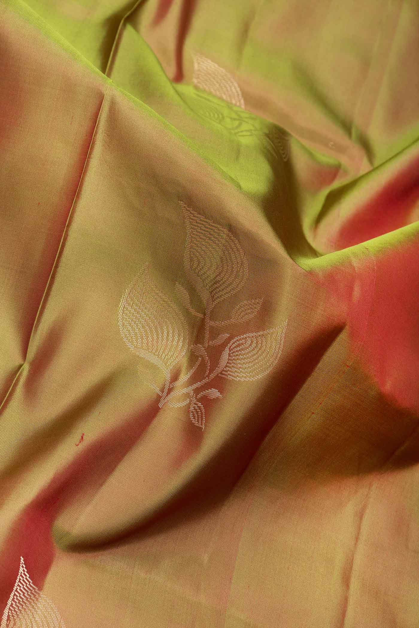 Close up of Green Dual Tone Soft Silk Saree with Zari Butta on the body and Zari Border.  displaying folds