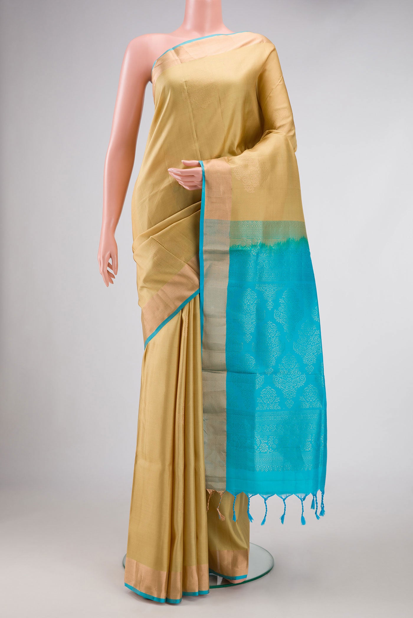 Sandal Dual Tone Soft Silk Saree with Zari Butta on the body and Zari Border.  displayed on a mannequin