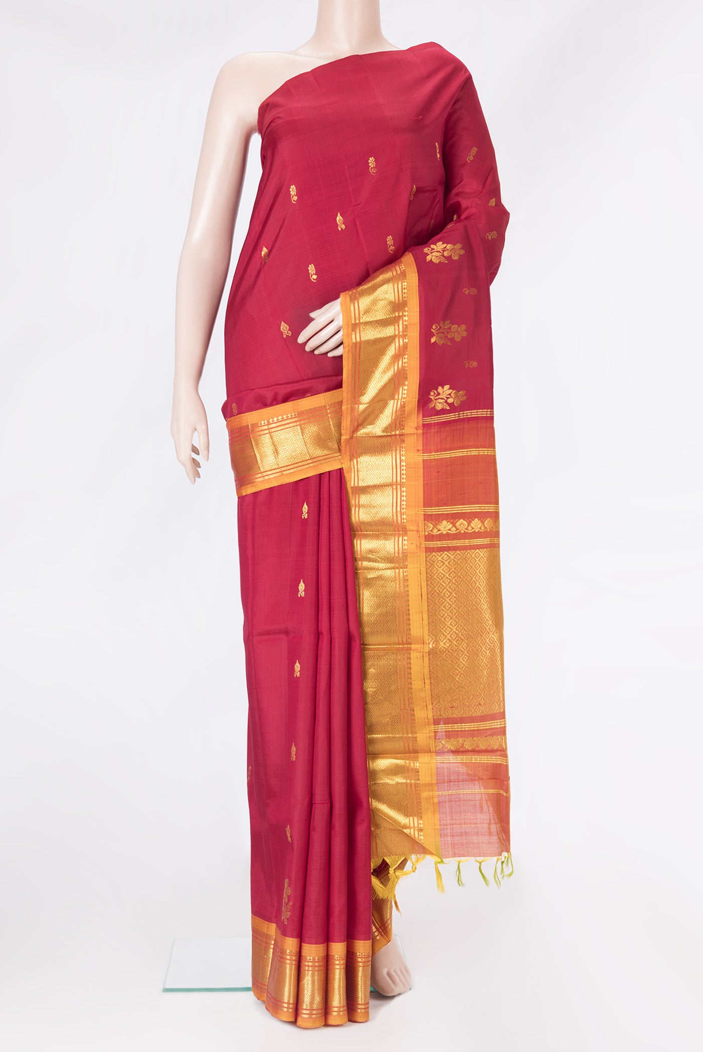 Maroon Kanjivaram Silk Saree with Zari Butta on the body and One Side Border.  displayed on a mannequin