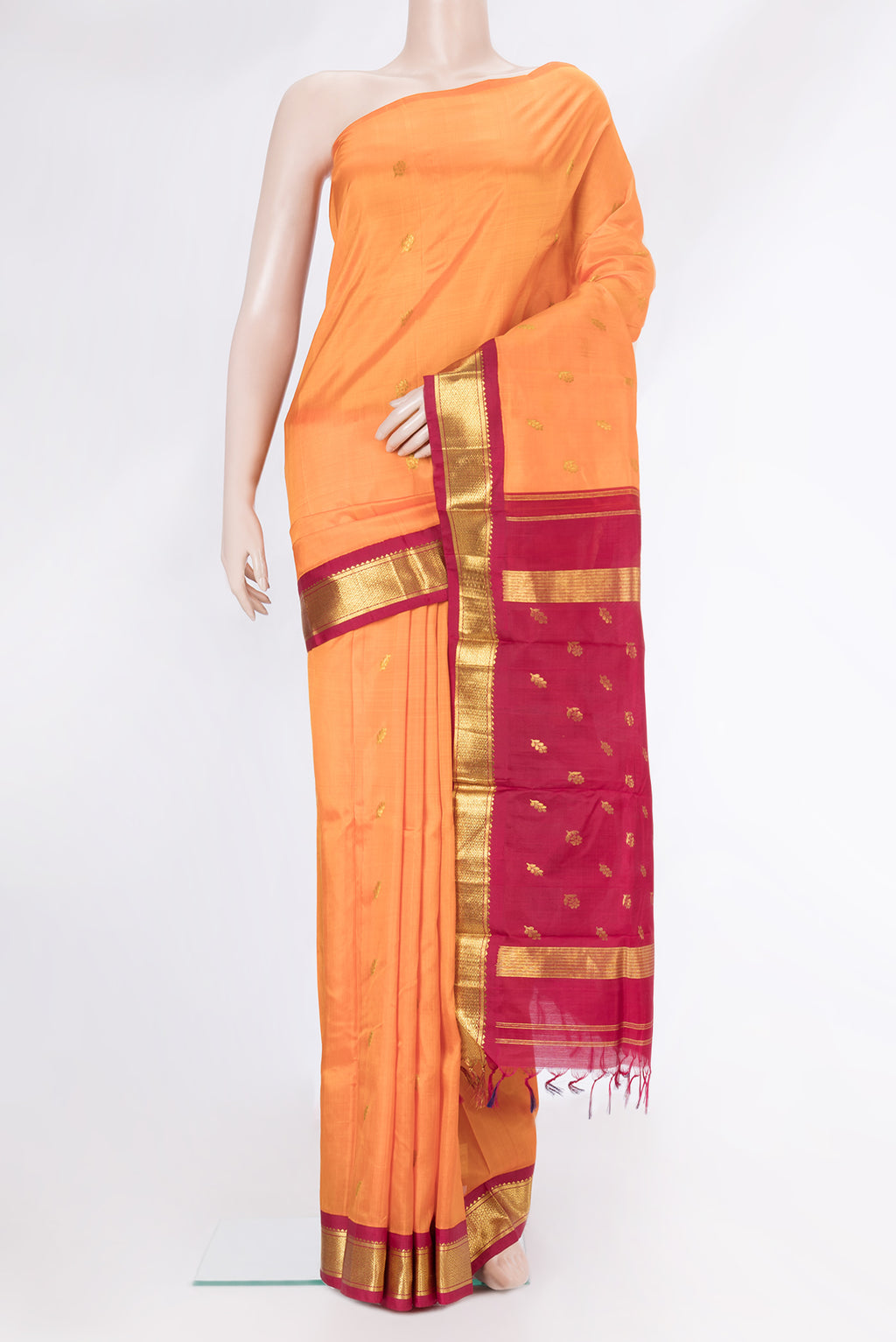 Orange Dual Tone Kanjivaram Silk Saree with Zari Butta on the body and One Side Border.  displayed on a mannequin