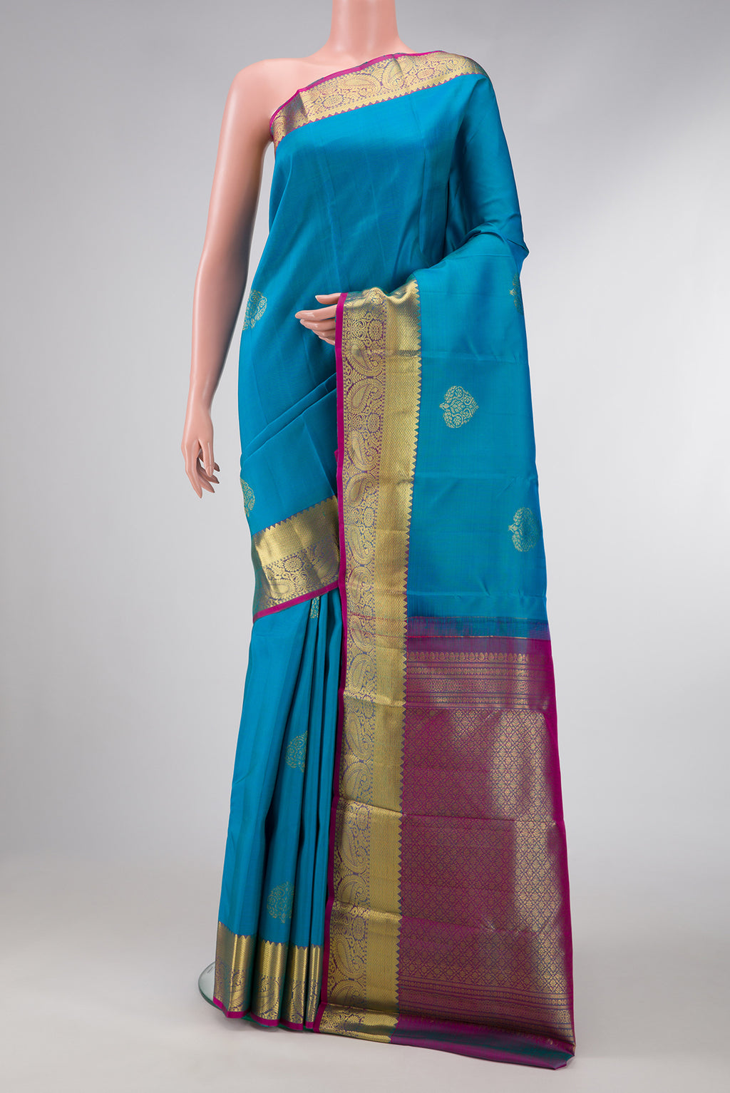 Sky Blue Dual Tone Kanjivaram Silk Saree with Zari Butta on the body and Zari Border.  displayed on a mannequin