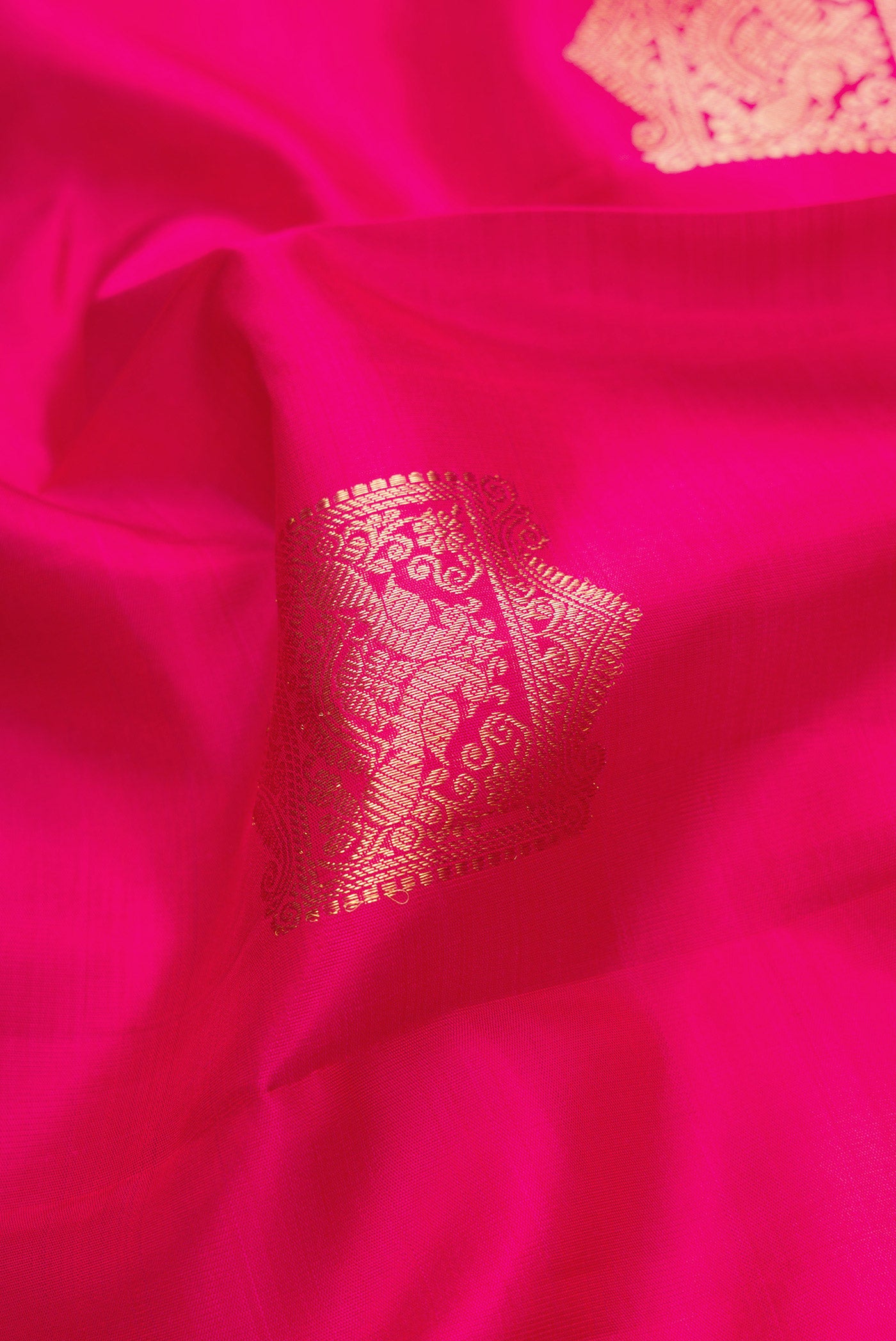 Close up of Pink Dual Tone Kanjivaram Silk Saree with Zari Butta on the body and Zari Border.  displaying folds