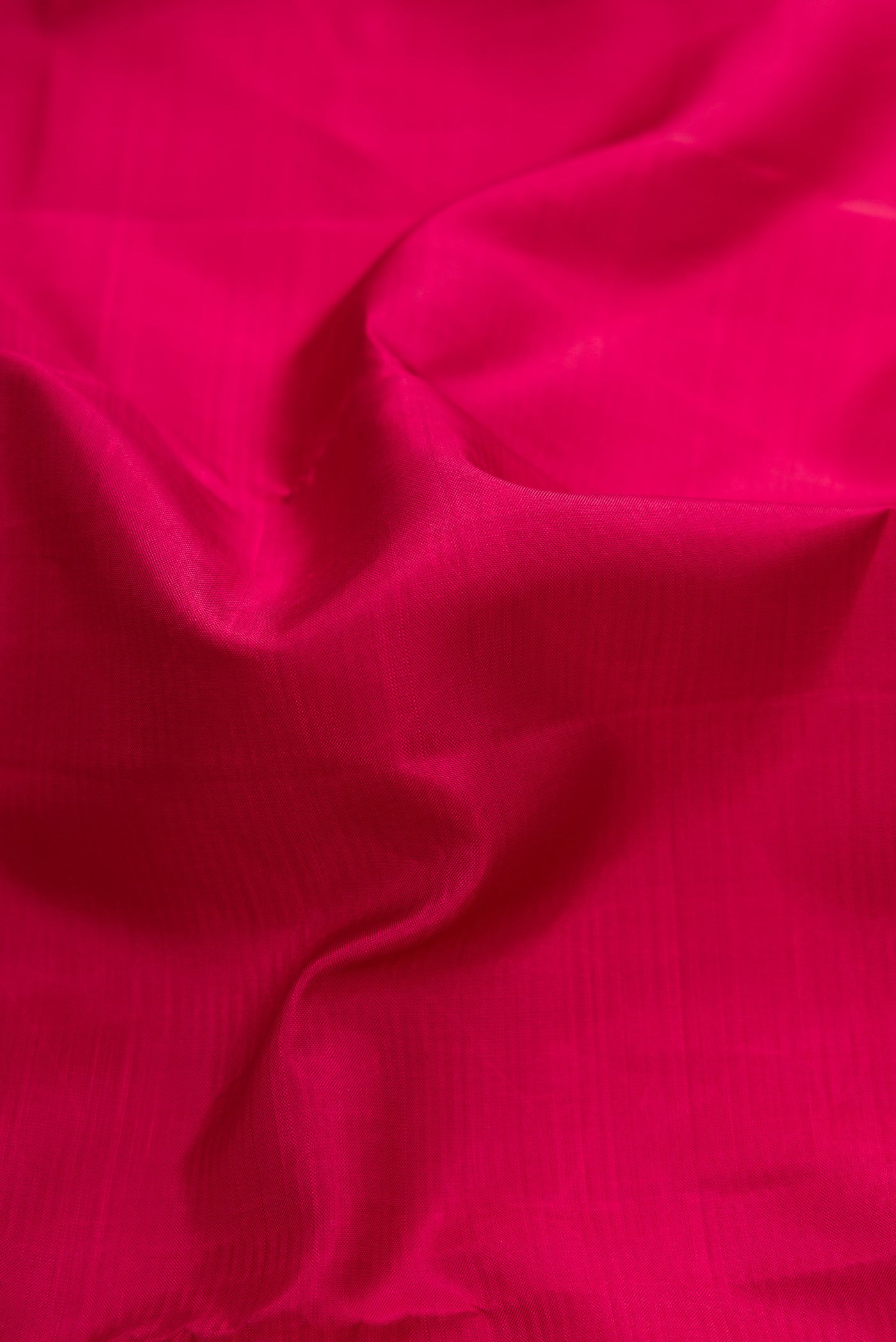 Close up of Maroon Dual Tone Kanjivaram Silk Saree with Plain Body and Zari Border.  displaying folds
