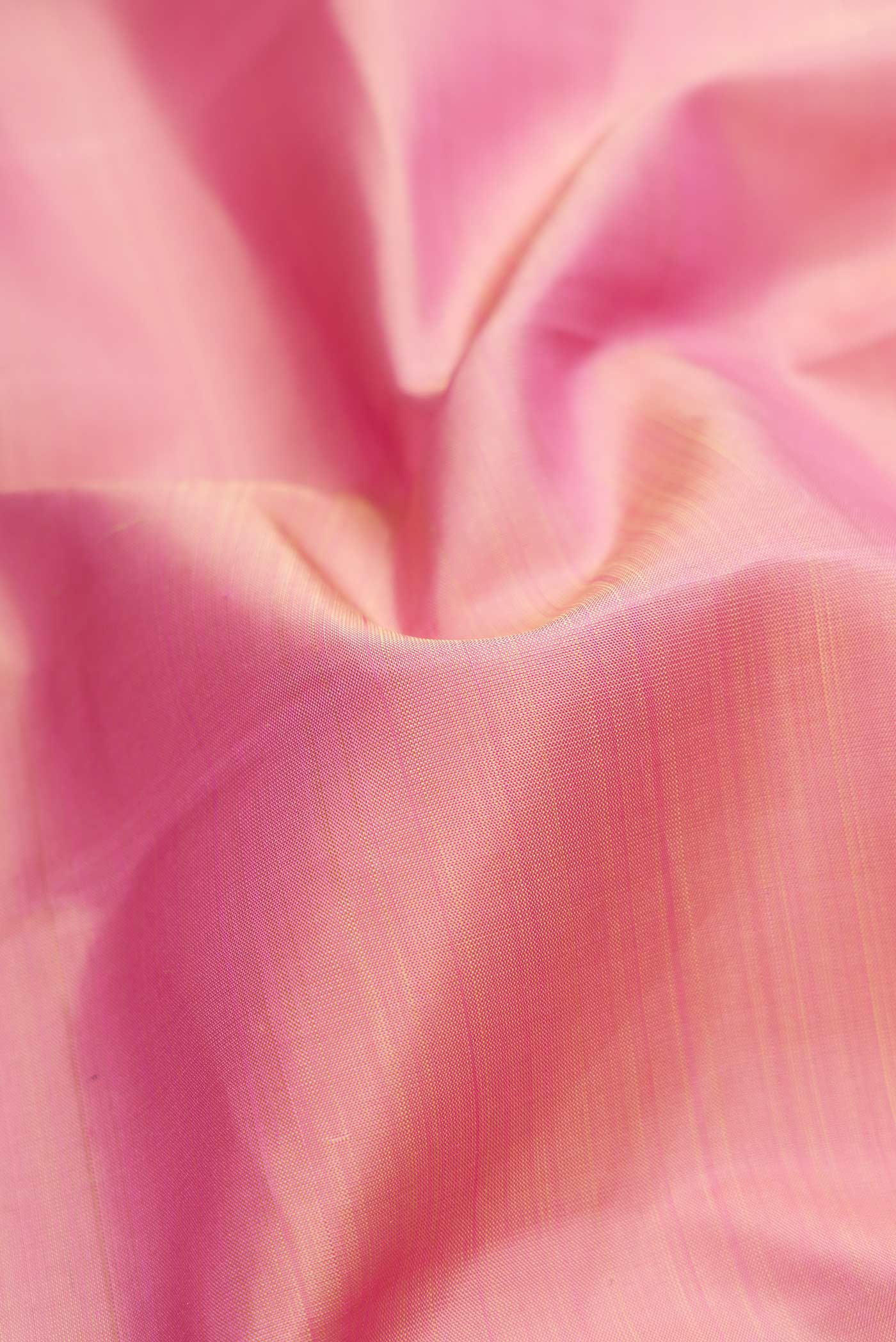 Close up of Pink Dual Tone Kanjivaram Silk Saree with Plain Body and Zari Border.  displaying folds
