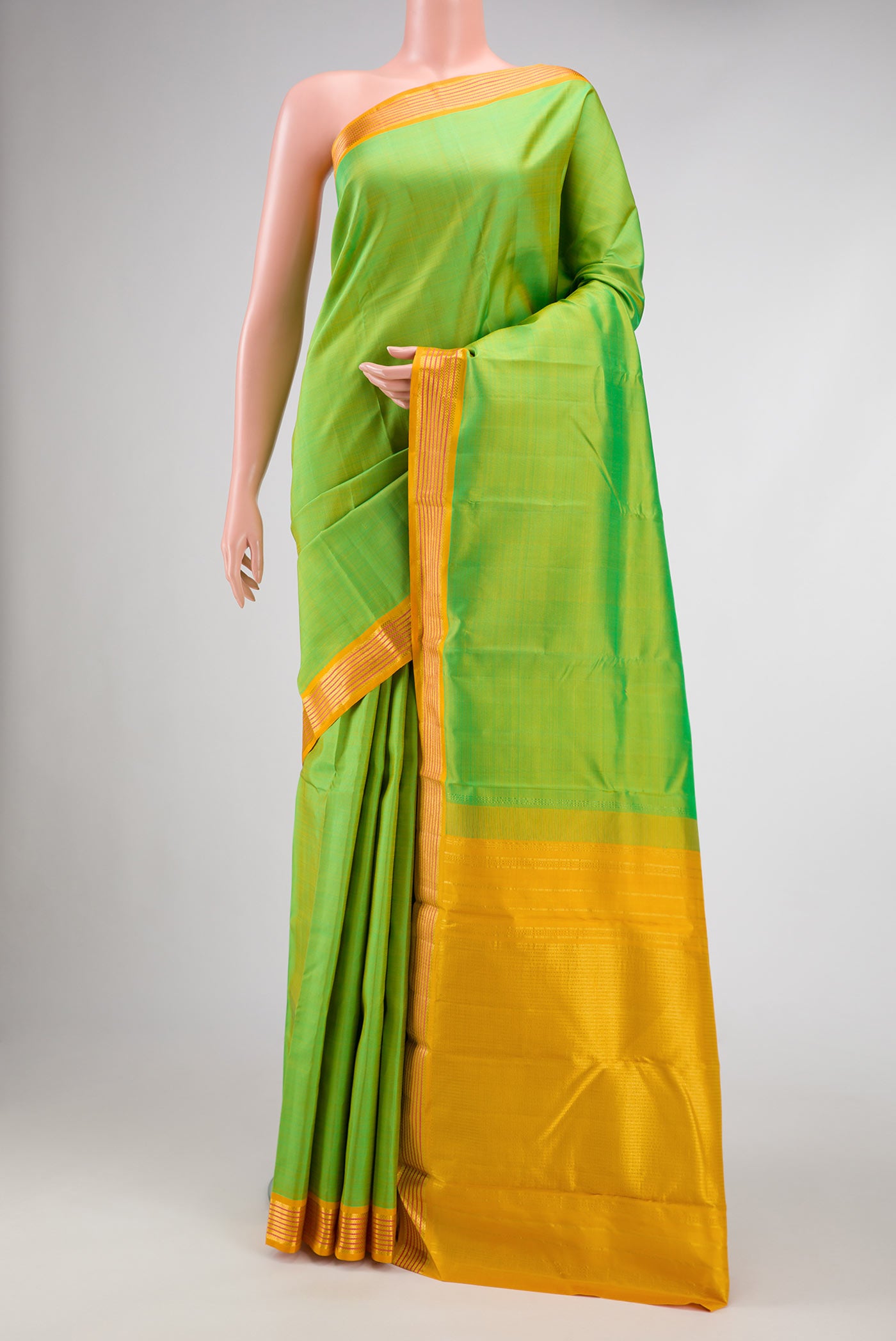 Parrot Green Dual Tone Kanjivaram Silk Saree with Plain Body and Zari Border.  displayed on a mannequin