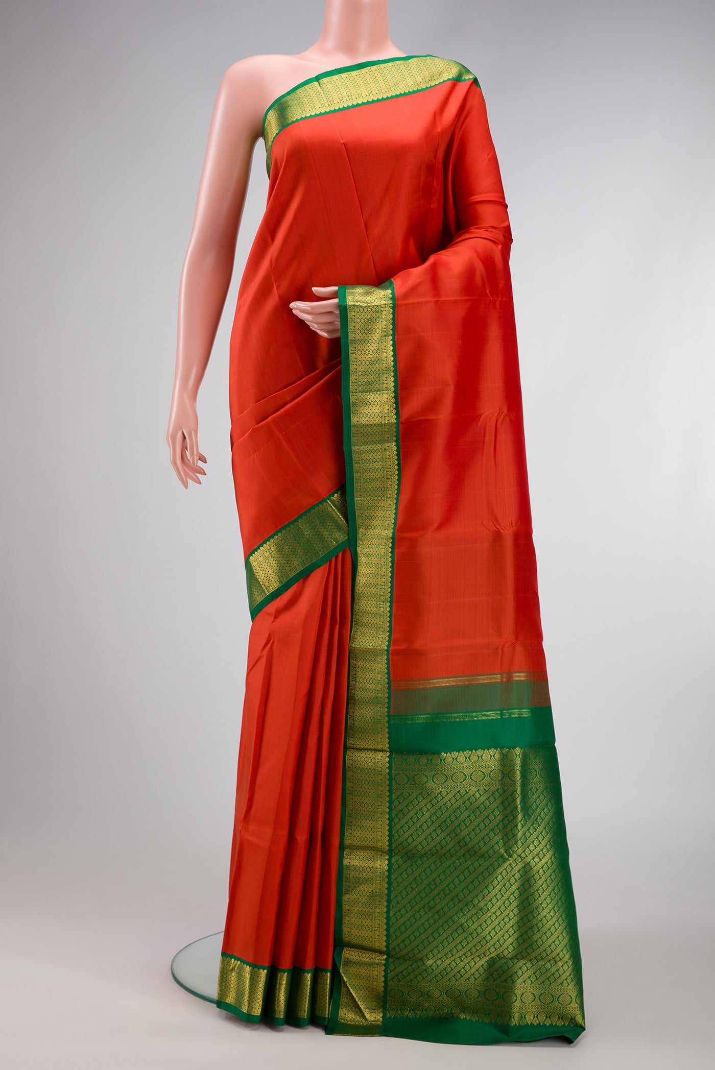 Brick Orange Dual Tone Kanjivaram Silk Saree with Plain Body and Zari Border.  displayed on a mannequin