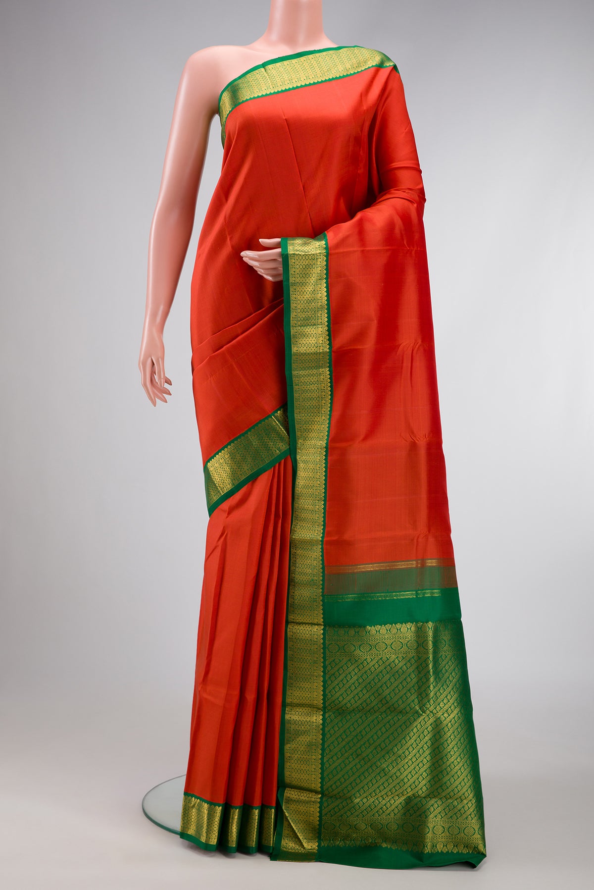 Brick Orange Dual Tone Kanjivaram Silk Saree with Plain Body and Zari Border.  displayed on a mannequin