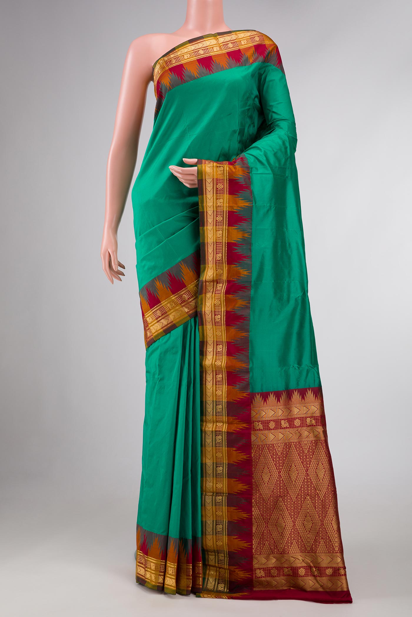 Green Bangalore Silk - kadyal Saree with Plain Body and Temple Border displayed on a mannequin