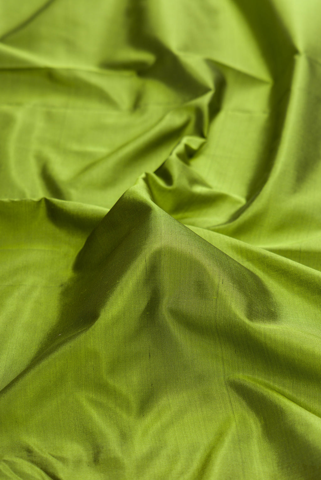 Close up of Pure Silk Mehandi Green Bangalore Saree with Plain Body and Temple Border.  displaying folds