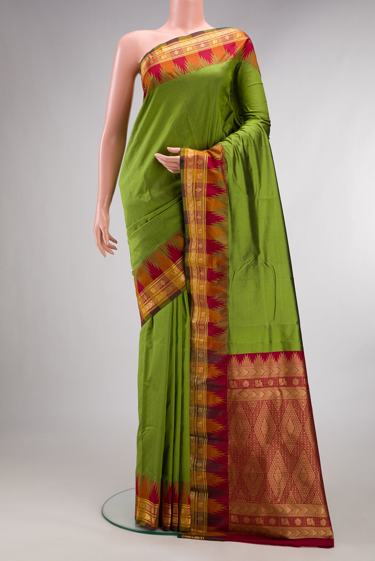 Pure Silk Mehandi Green Bangalore Saree with Plain Body and Temple Border.  displayed on a mannequin