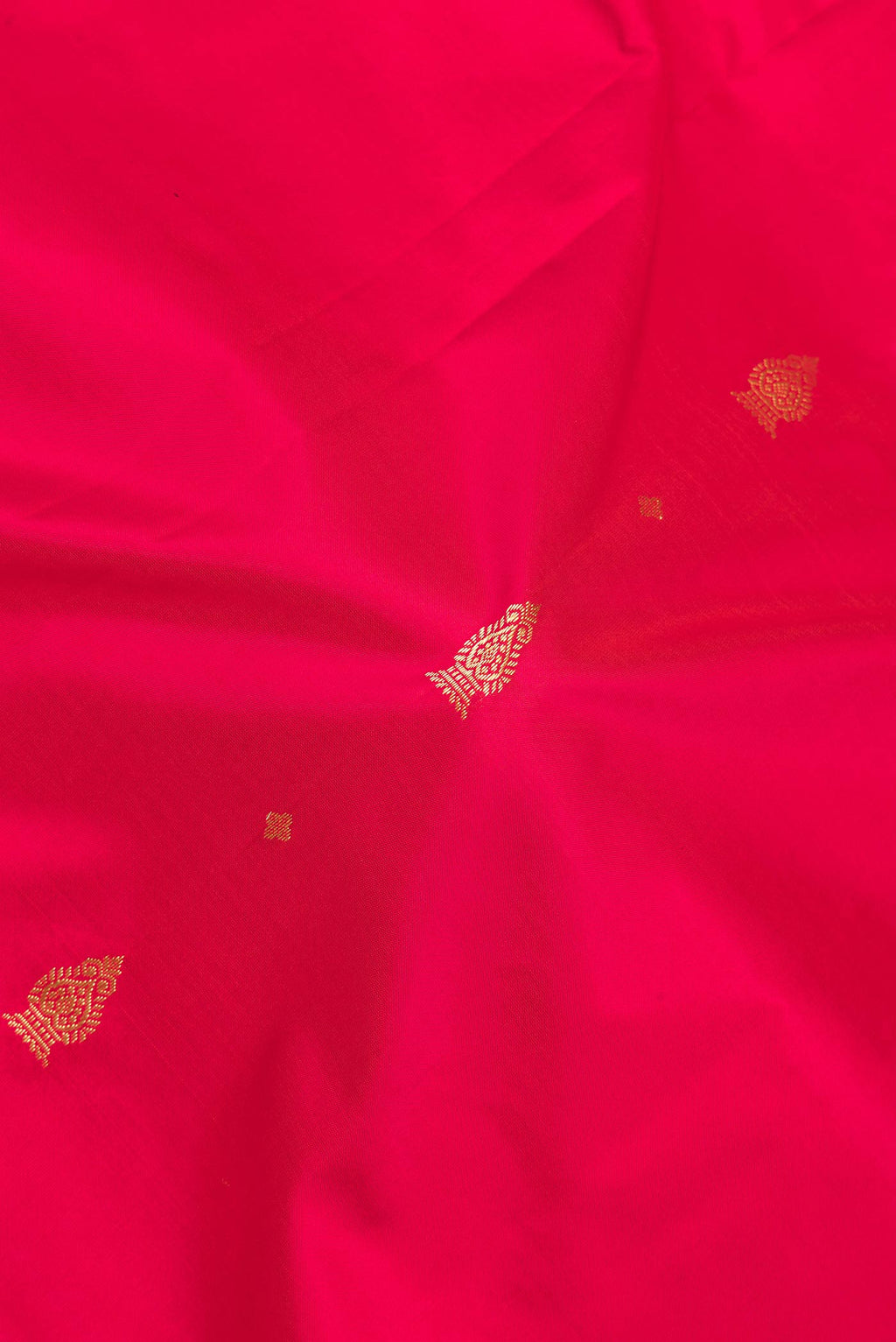 Close up of Pure Silk Red Bangalore Saree with Zari Butta on the body and Temple Border.  displaying folds