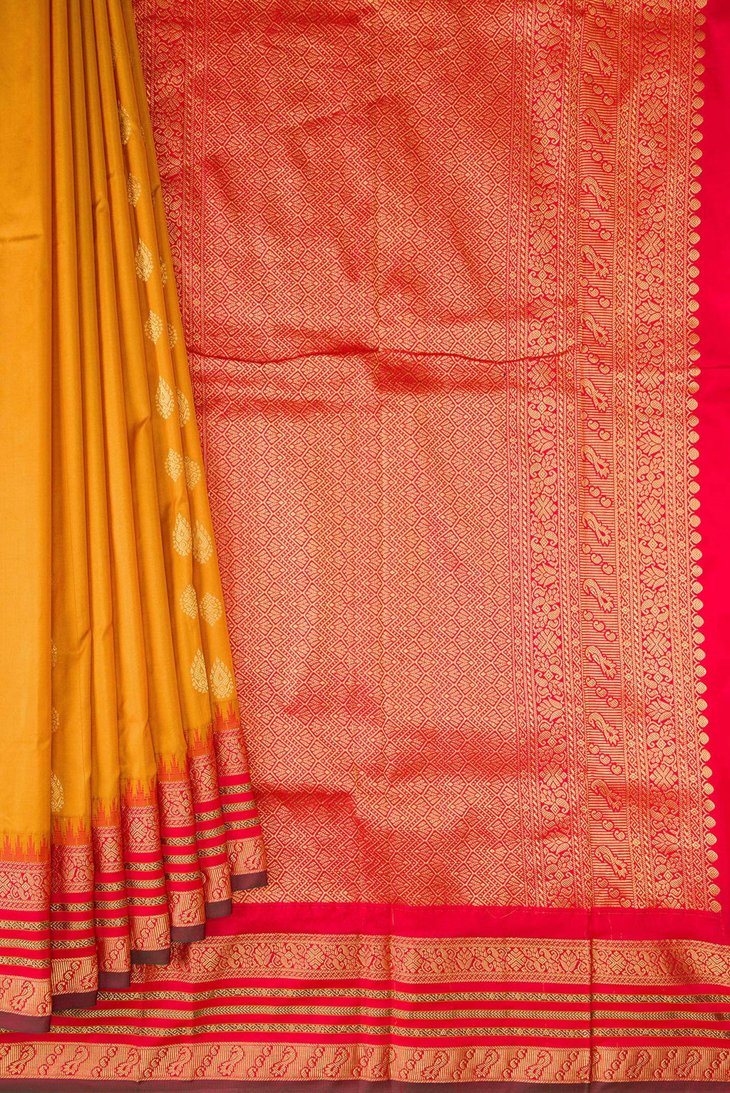 Pleats and pallu of Pure Silk Mustard Bangalore Saree with Zari Butta on the body and Temple Border. 
