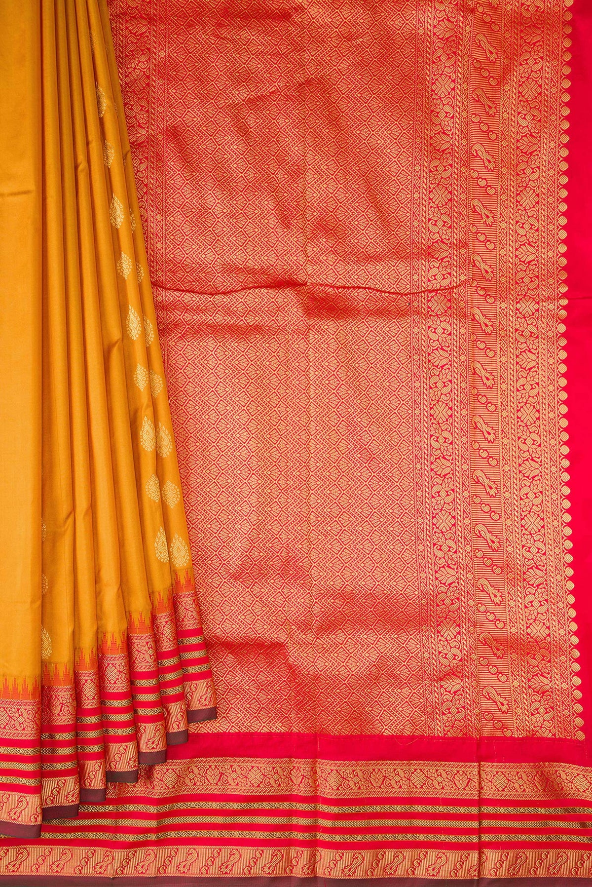 Pleats and pallu of Pure Silk Mustard Bangalore Saree with Zari Butta on the body and Temple Border. 