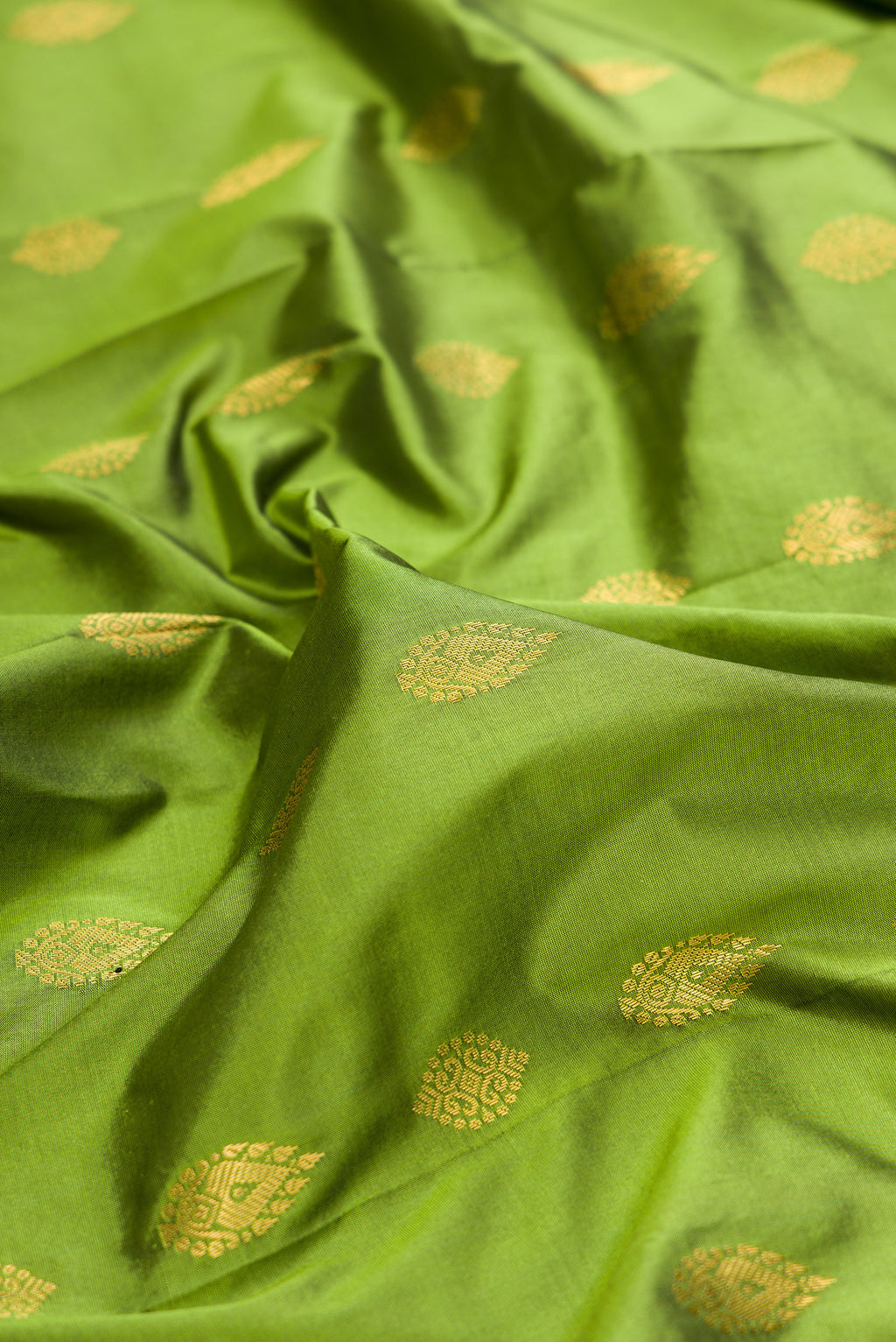 Close up of Pure Silk Mehandi Green Bangalore Saree with Zari Butta on the body and Temple Border.  displaying folds