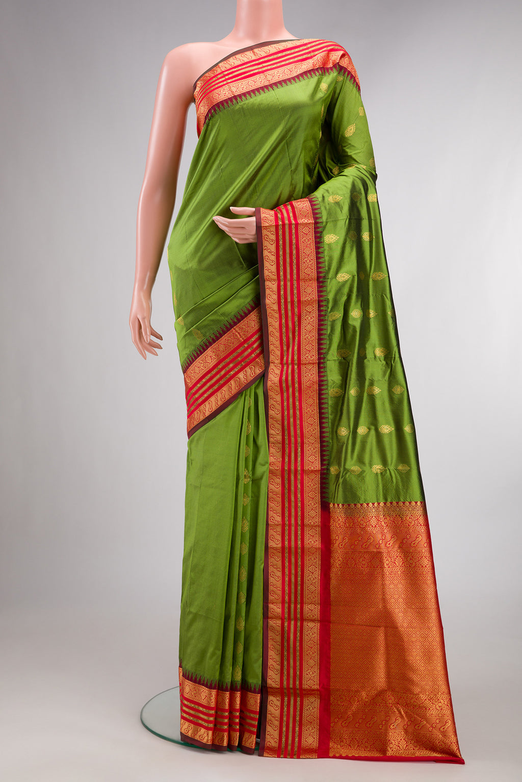 Pure Silk Mehandi Green Bangalore Saree with Zari Butta on the body and Temple Border.  displayed on a mannequin