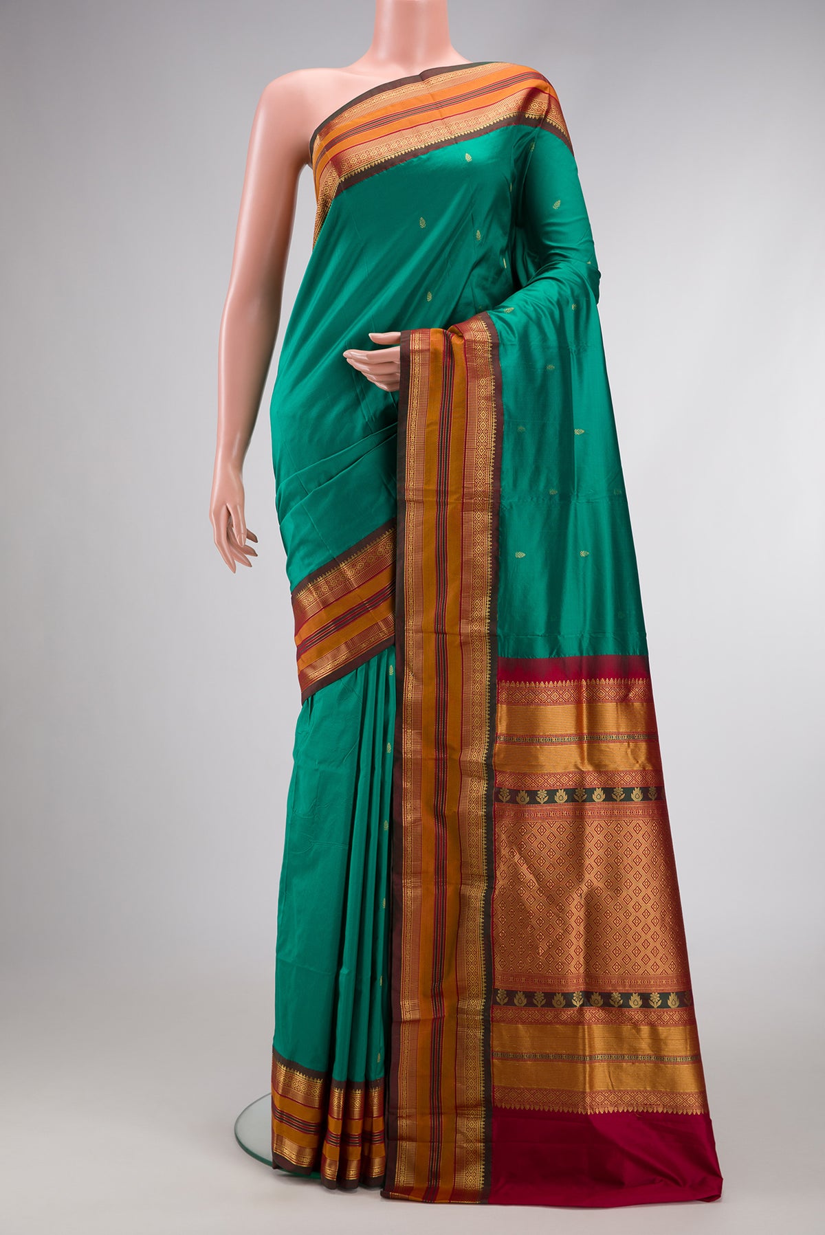 Green Dual Tone Kanchipuram Silk Saree with Zari Butta on the body and Zari Border.  displayed on a mannequin