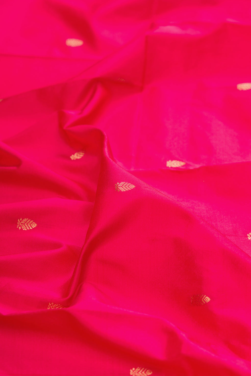 Close up of Pure Silk Dark Pink Bangalore Saree with Zari Butta on the body and Zari Border.  displaying folds