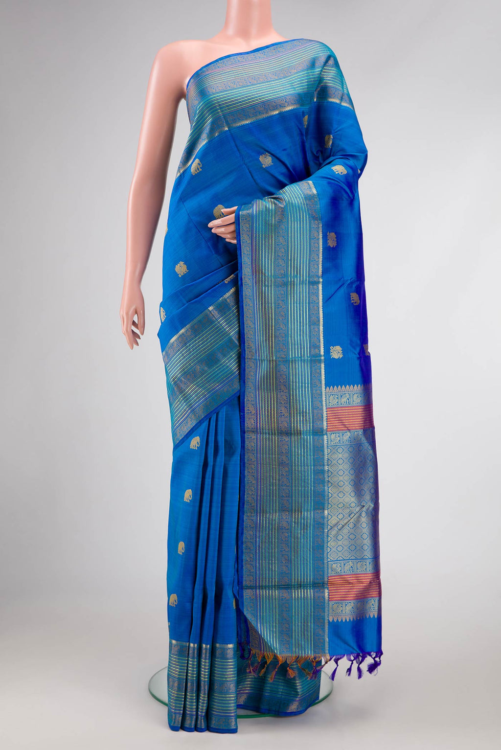Royal Blue Dual Tone Kanjivaram Silk Saree with Thread Butta on the body and Zari And Thread Border.  displayed on a mannequin