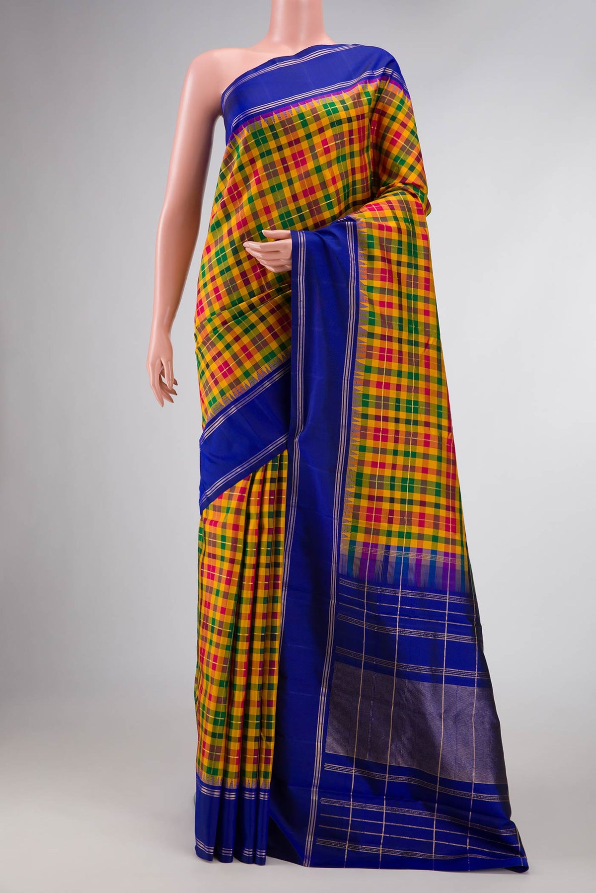 Mustard, Green and Maroon Color Kanchipuram Silk Saree with Checked design on the body and Zari Border displayed on a mannequin