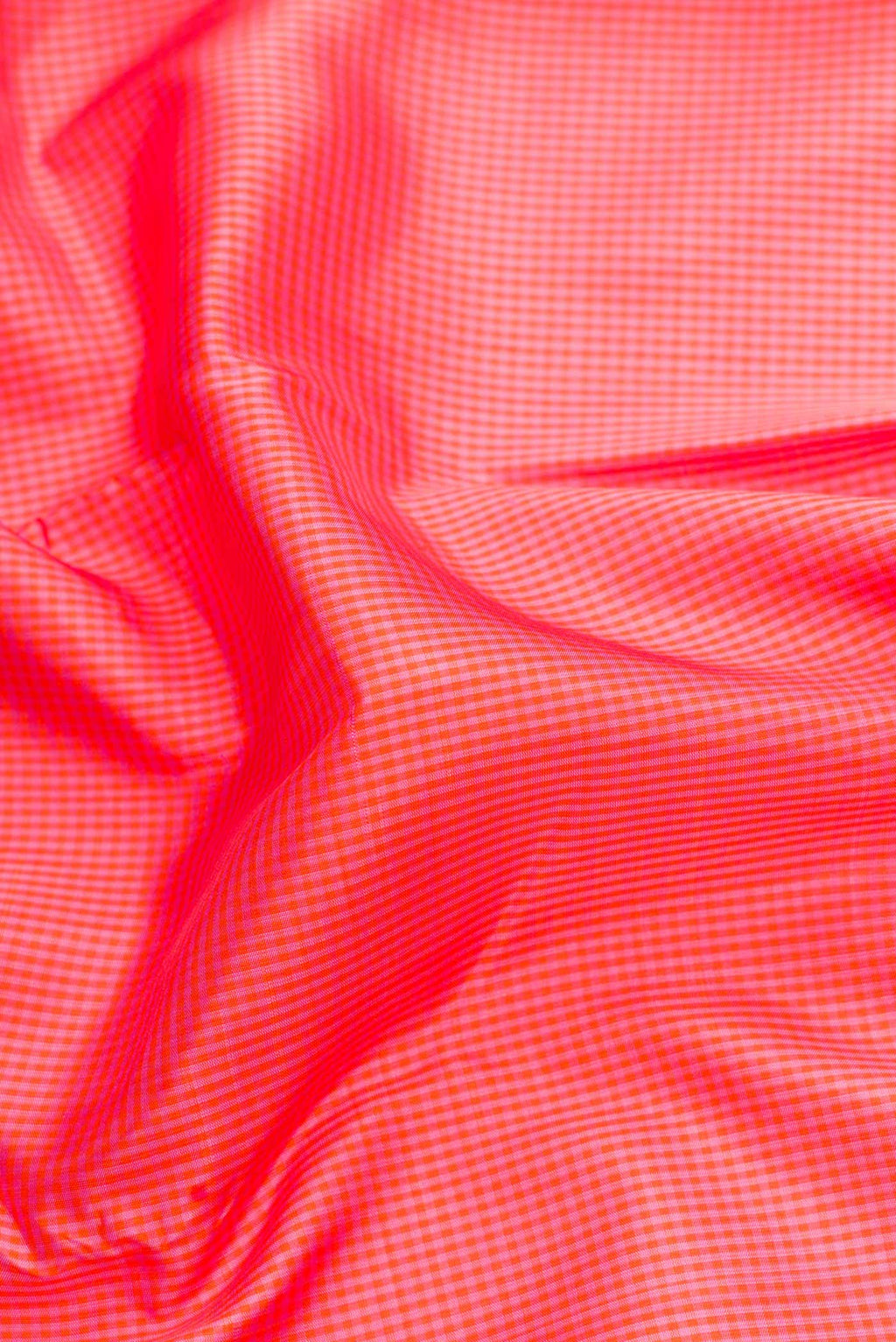 Close up of Golden Peach Dual Tone Kanchipuram Silk Saree with Checked design on the body and Thin Zari Line.  displaying folds