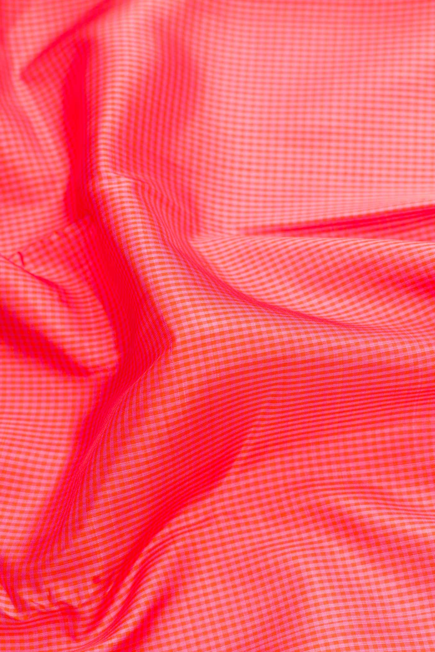 Close up of Golden Peach Dual Tone Kanchipuram Silk Saree with Checked design on the body and Thin Zari Line.  displaying folds