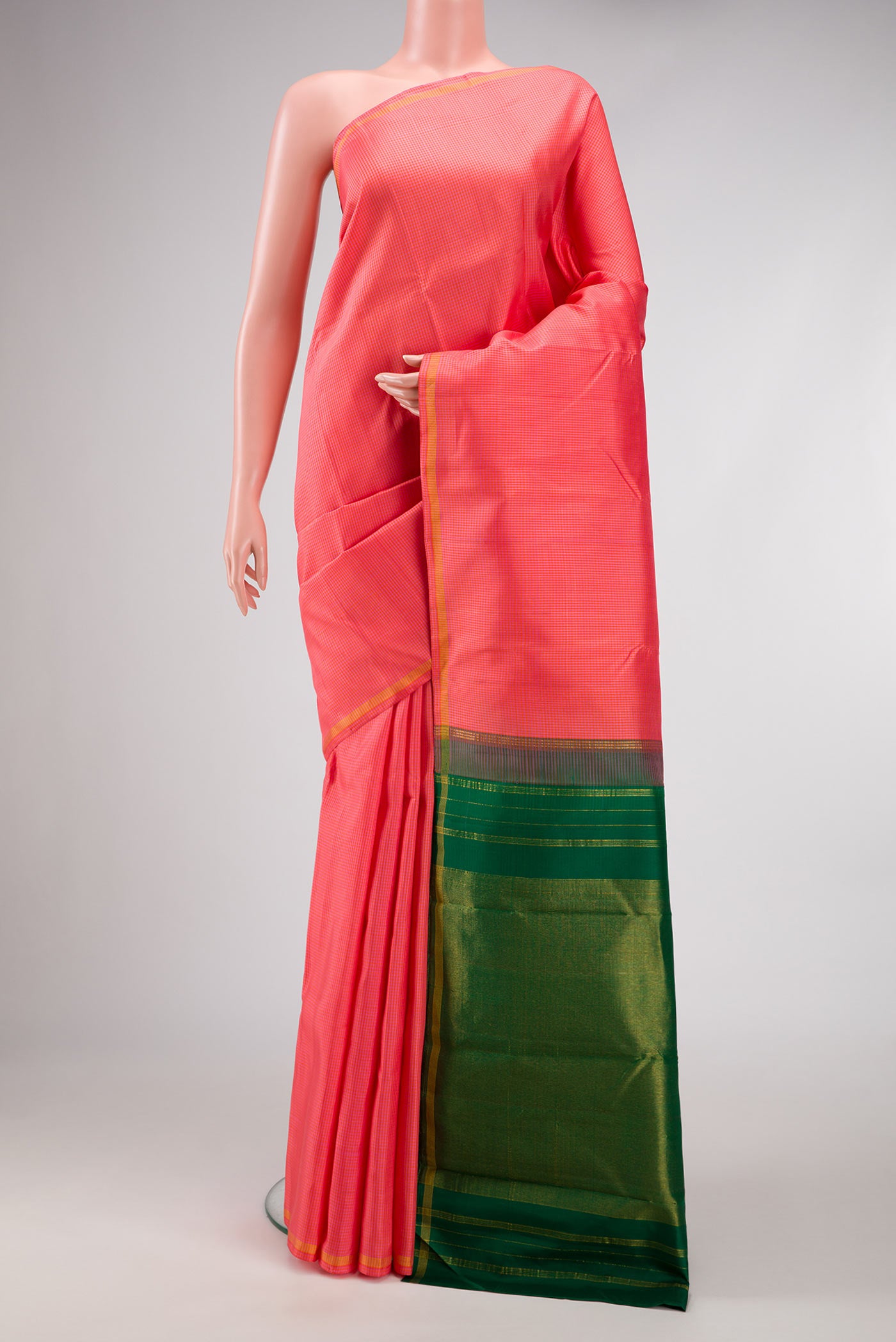 Golden Peach Dual Tone Kanchipuram Silk Saree with Checked design on the body and Thin Zari Line.  displayed on a mannequin