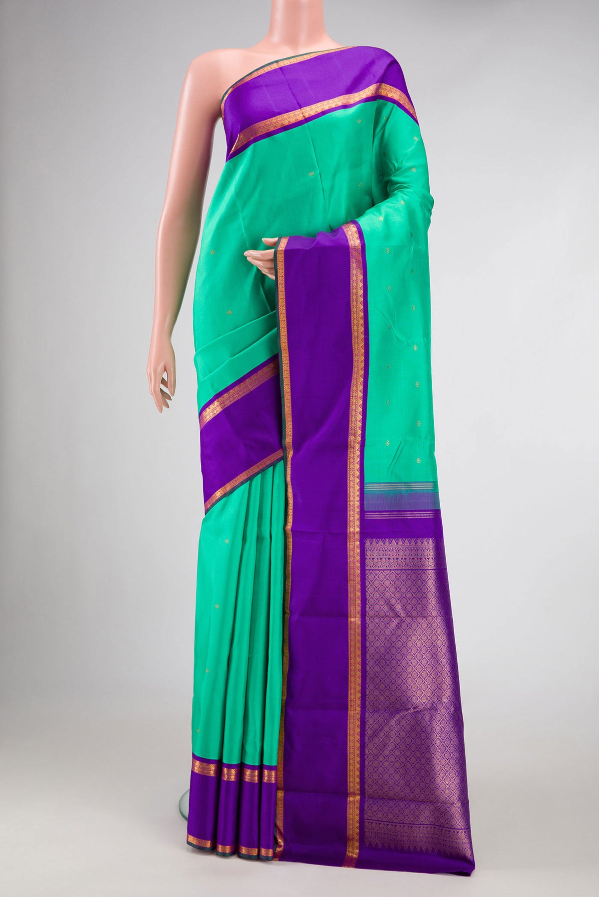 Sea Green Dual Tone Kanjivaram Silk Saree with Zari Butta on the body and Zari Border.  displayed on a mannequin