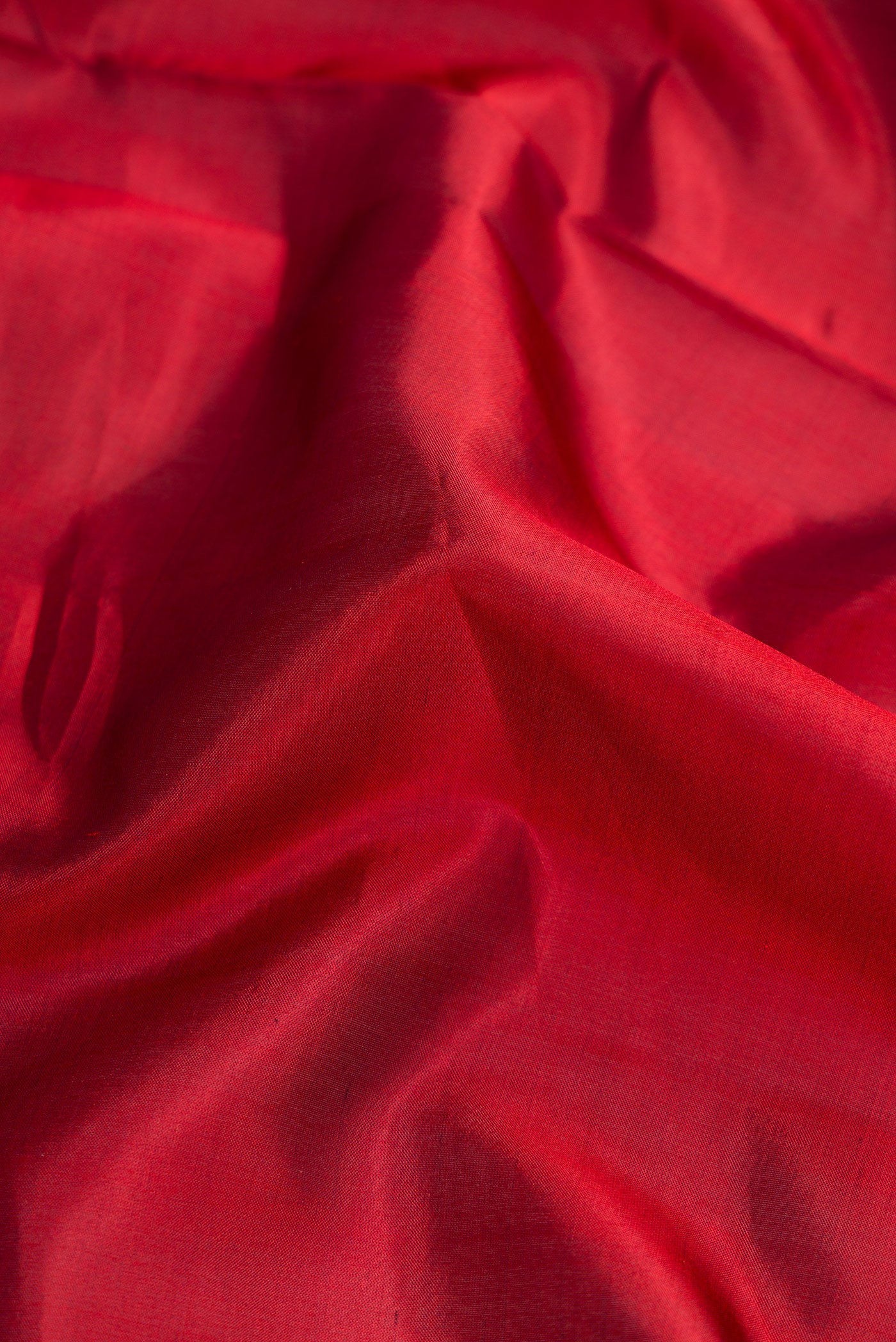 Close up of Maroon Dual Tone Kanchipuram Silk Nine Yards Saree with Plain Body and Zari Border.  displaying folds