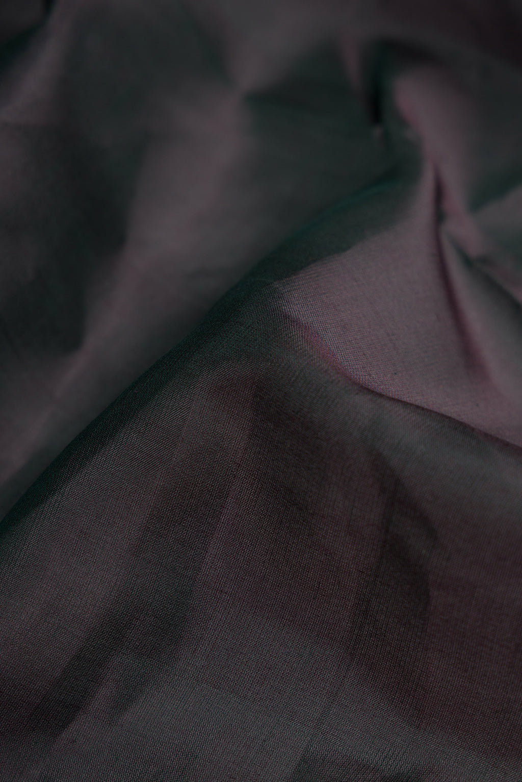 Close up of Black Dual Tone Kanjivaram Silk Nine Yards Saree with Plain Body and Zari Border.  displaying folds