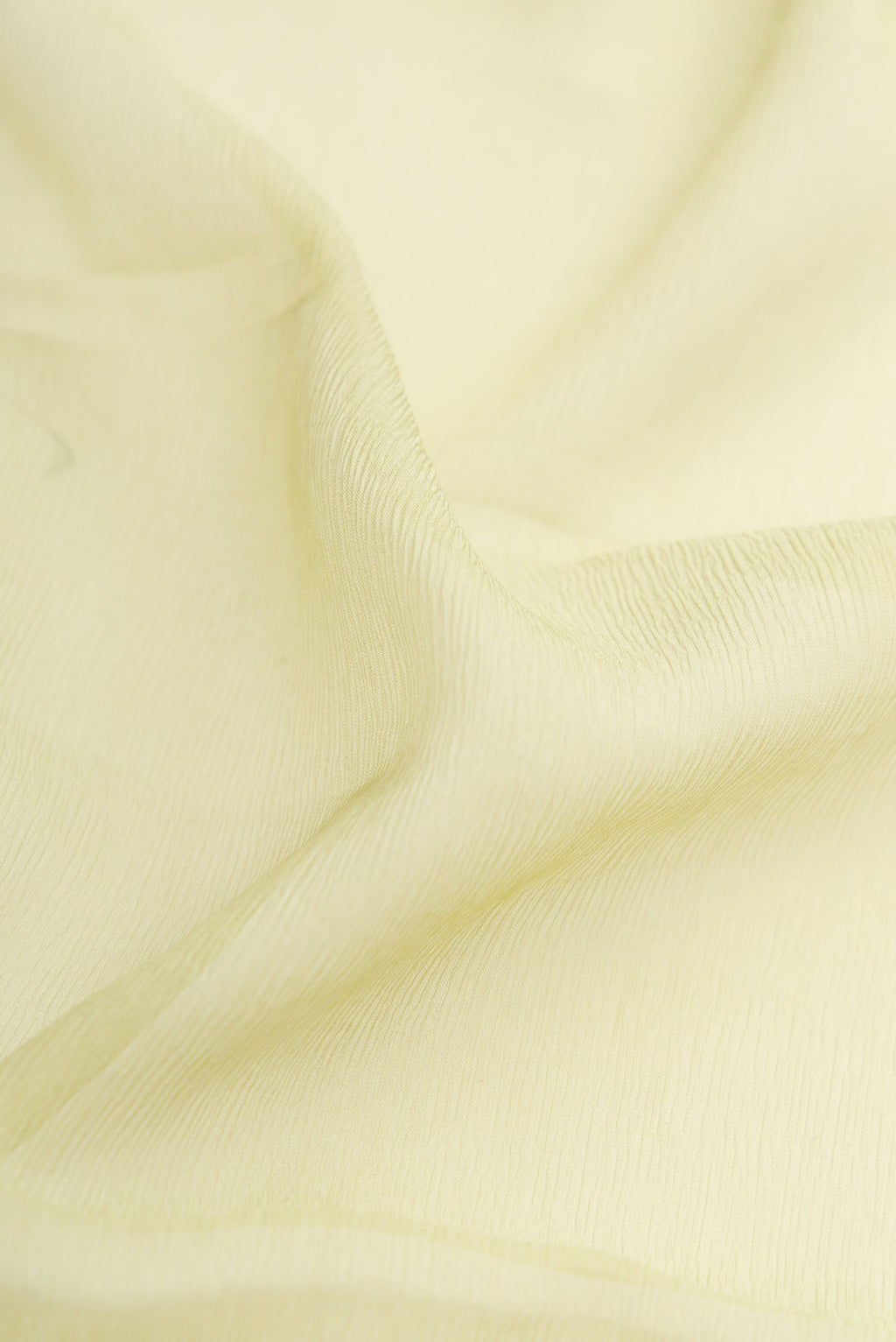 Close up of Pista Green Dual Tone Mysore Chiffon Saree with Plain Body and Plain Border.  displaying folds