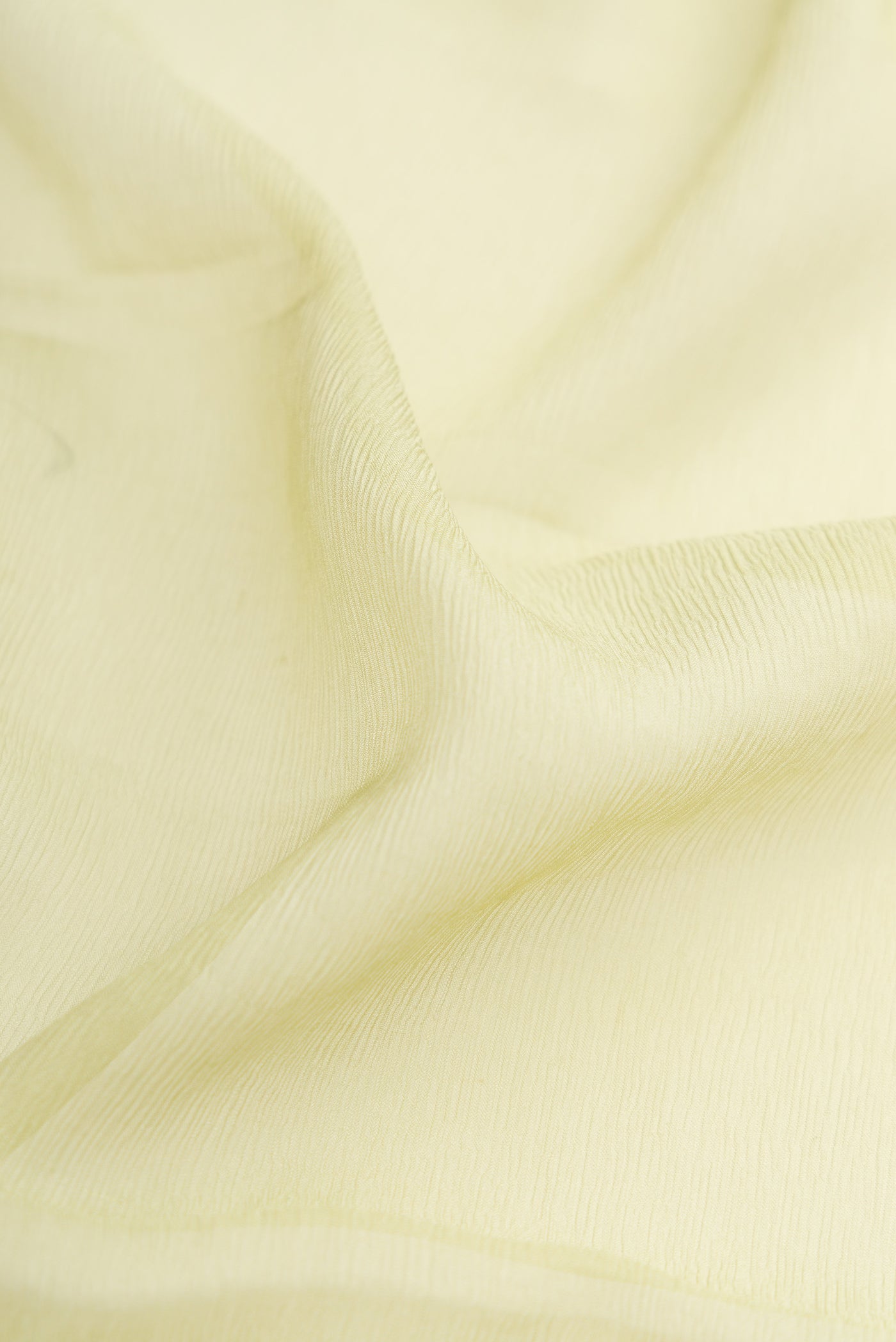 Close up of Pista Green Dual Tone Mysore Chiffon Saree with Plain Body and Plain Border.  displaying folds