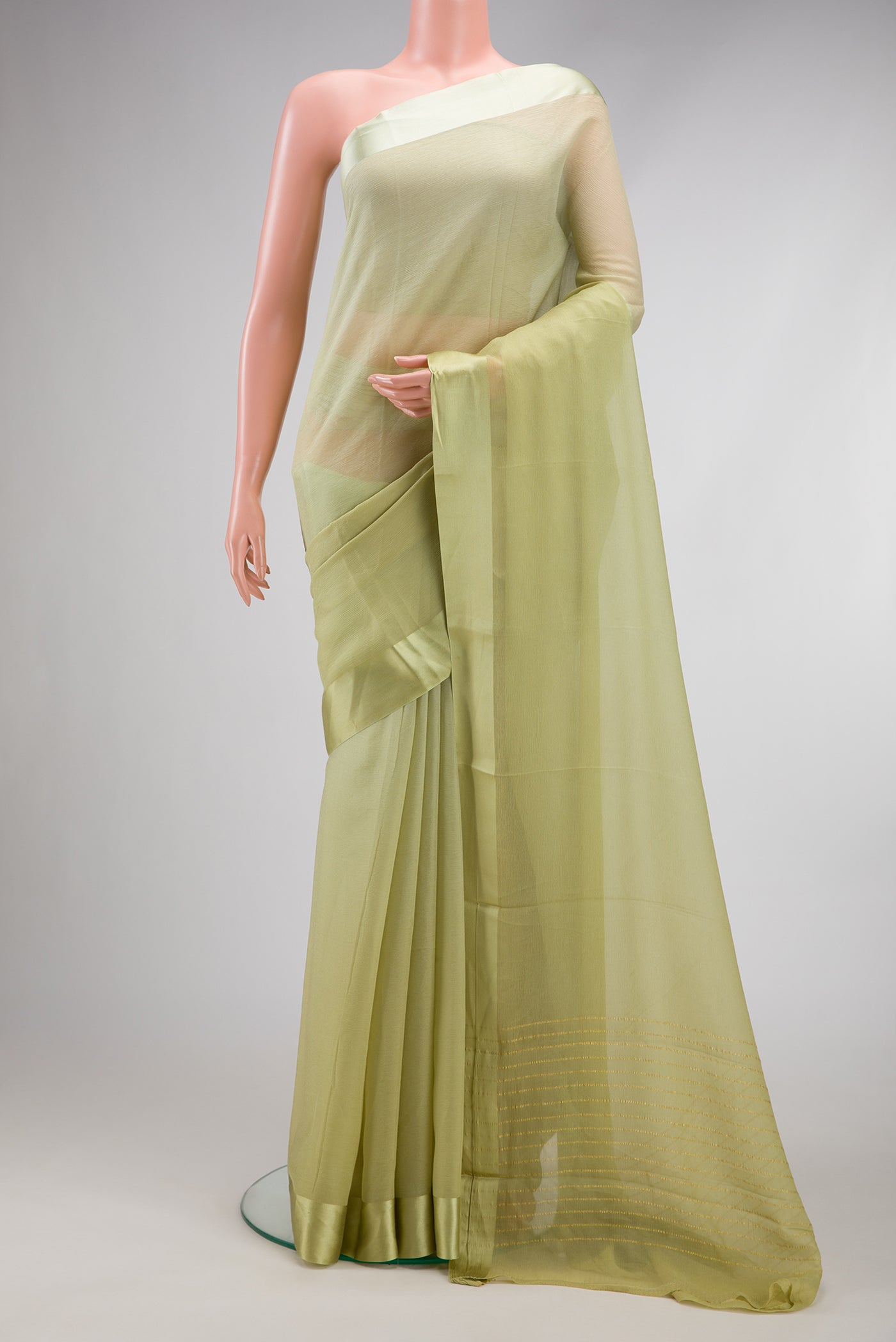 Pista Green Dual Tone Mysore Chiffon Saree with Plain Body and Plain Border.  displayed on a mannequin
