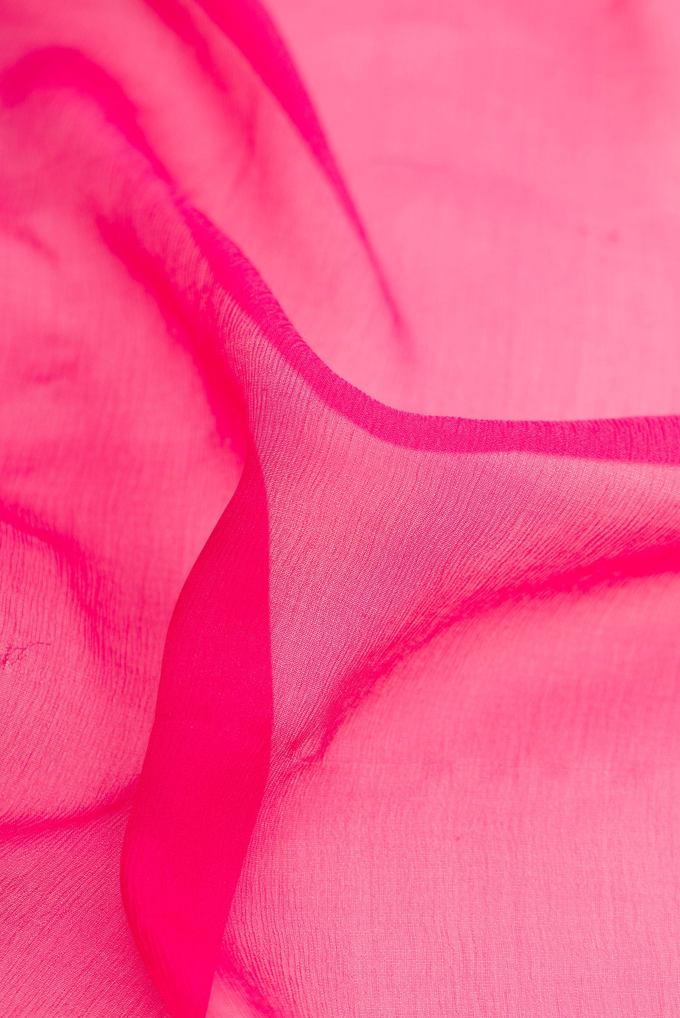 Close up of Pink Dual Tone Mysore Chiffon Saree with Plain Body and Zari Border.  displaying folds