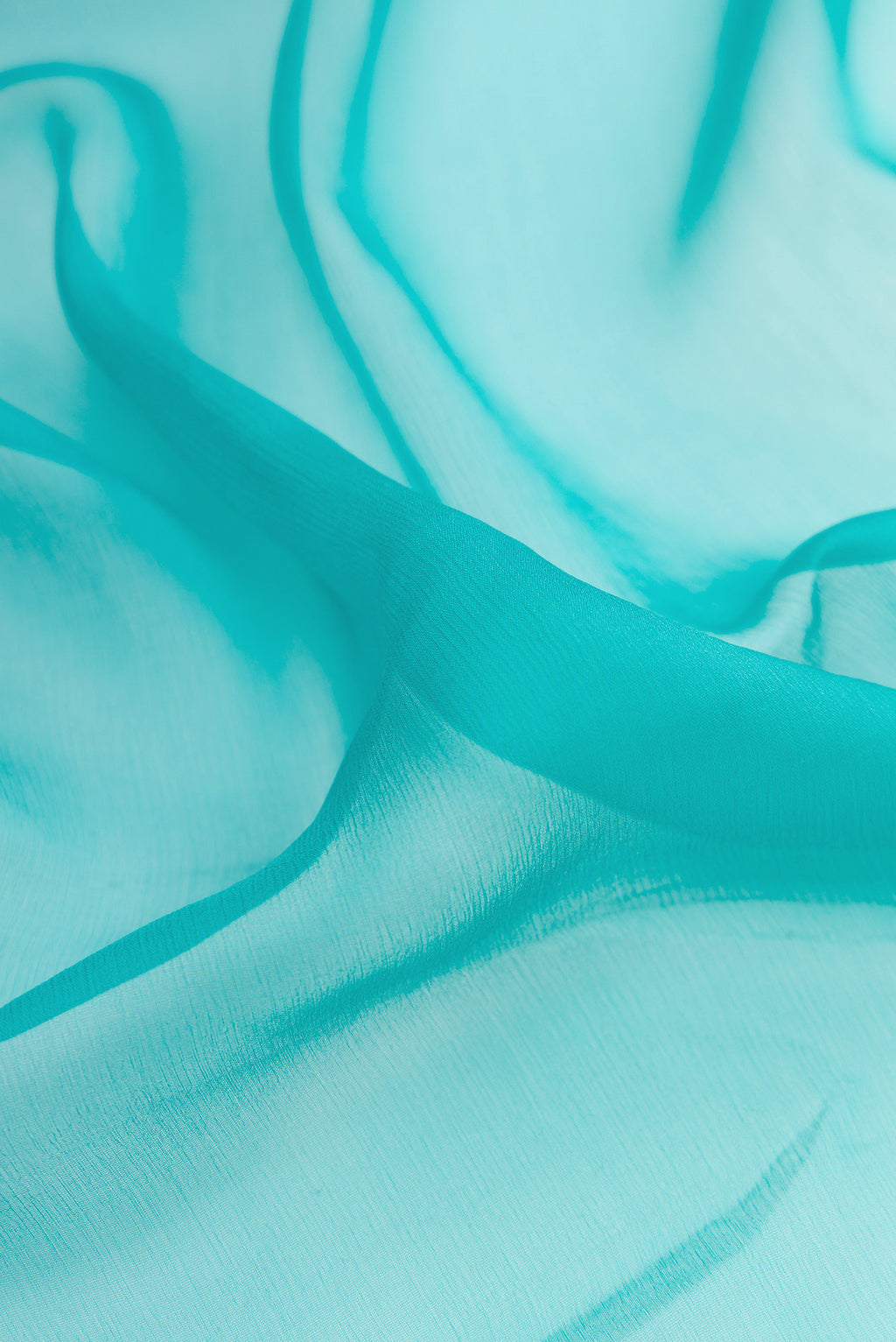 Close up of Sky Blue Mysore Chiffon Saree with Plain Body and Zari Border.  displaying folds