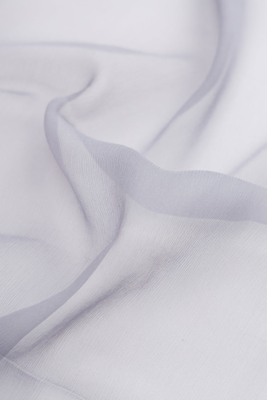 Close up of Grey Mysore Chiffon Saree with Plain Body and Zari Border.  displaying folds