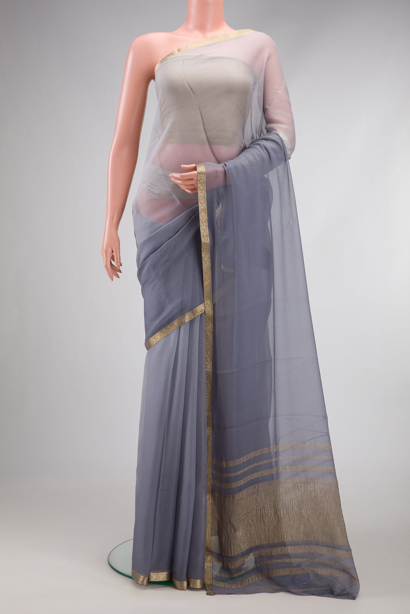 Grey Mysore Chiffon Saree with Plain Body and Zari Border.  displayed on a mannequin