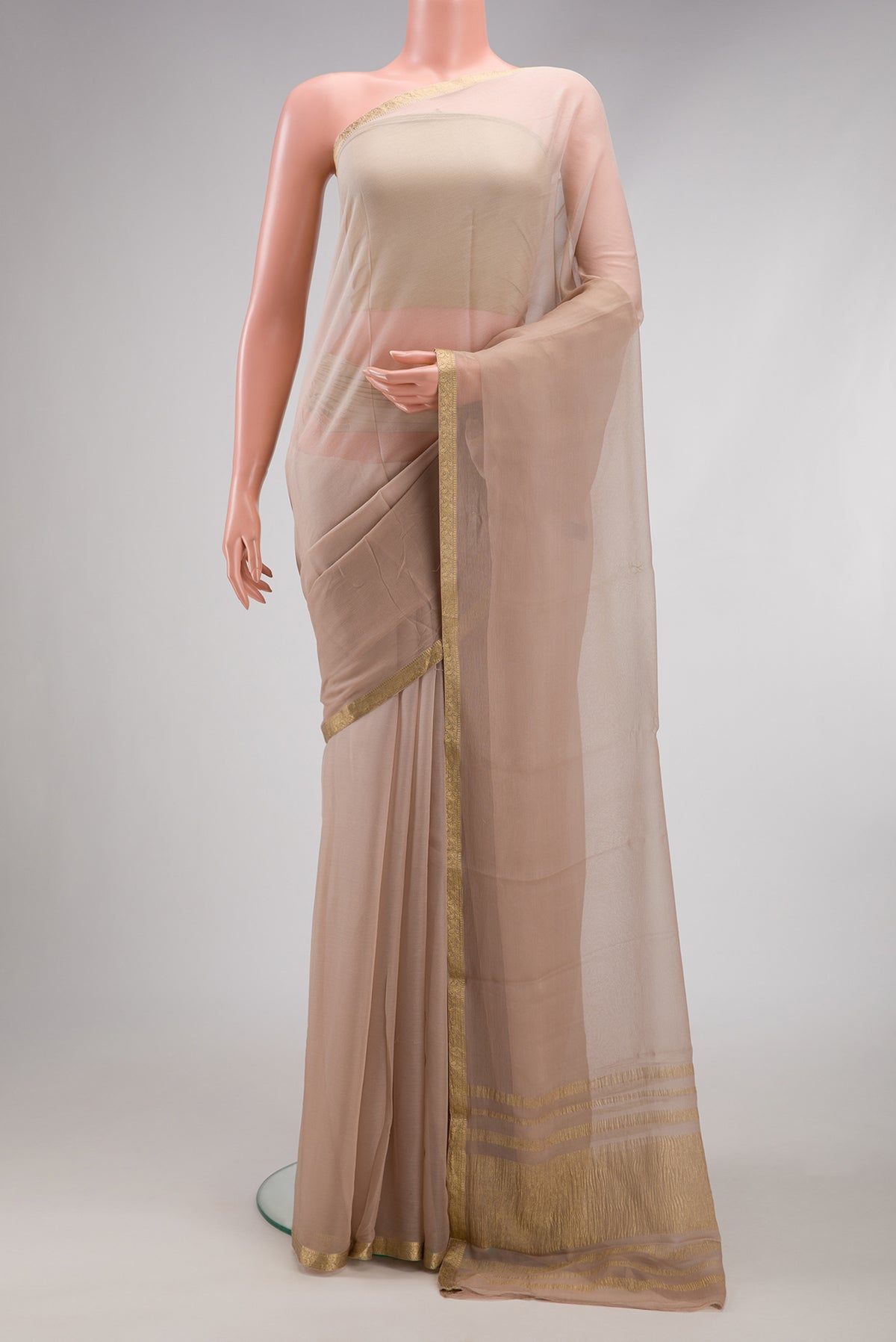 Beige Mysore Chiffon Saree with Plain Body and Zari Border.  displayed on a mannequin