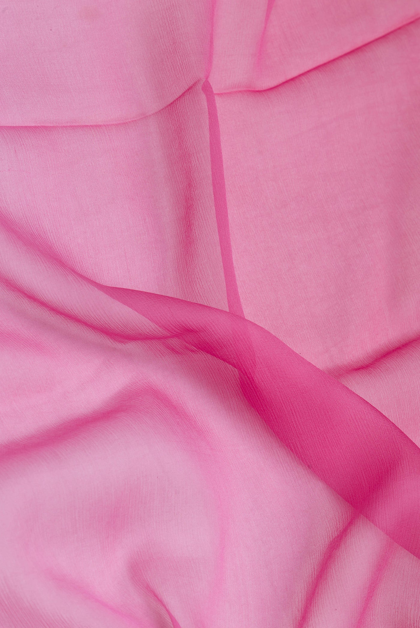 Close up of Pink Mysore Chiffon Saree with Ombre design on the body and Zari Border.  displaying folds