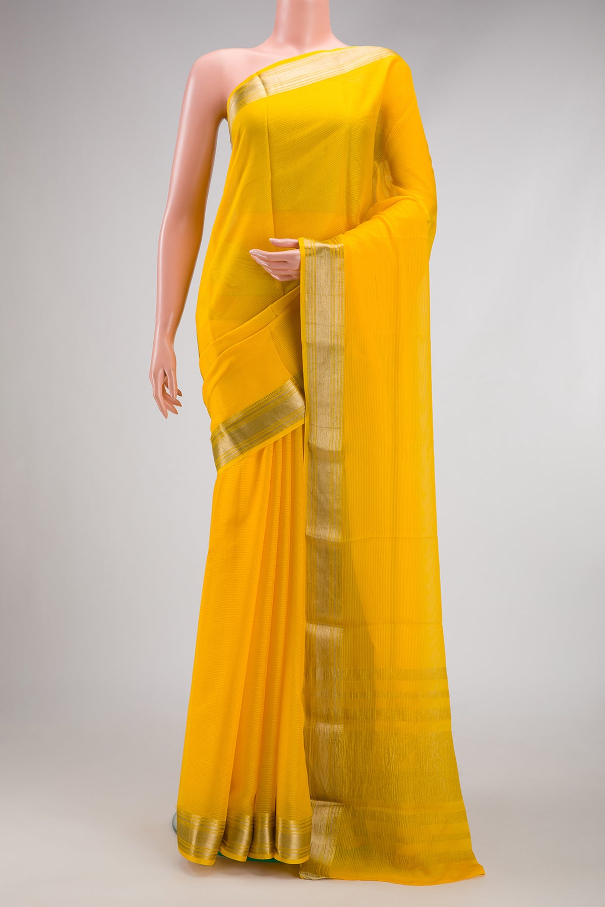 Yellow Mysore Georgette Saree with Plain Body and Zari Border.  displayed on a mannequin