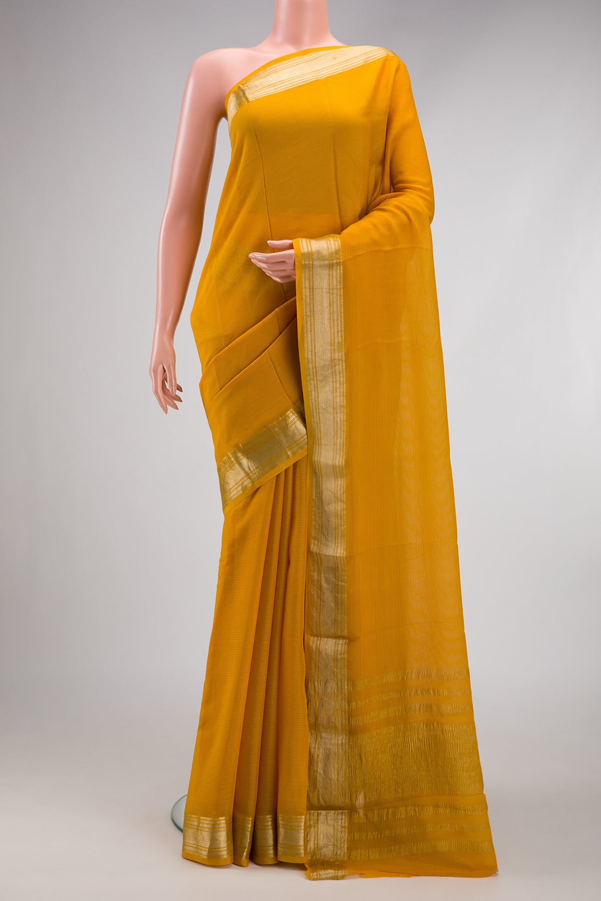 Mustard Mysore Georgette Saree with Stripes on the body and Zari Border.  displayed on a mannequin