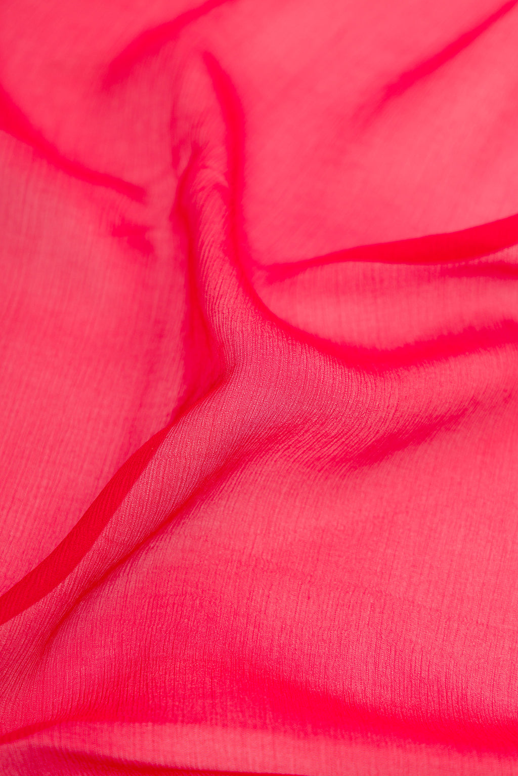 Close up of Red Mysore Chiffon Saree with Plain Body and Zari Border.  displaying folds