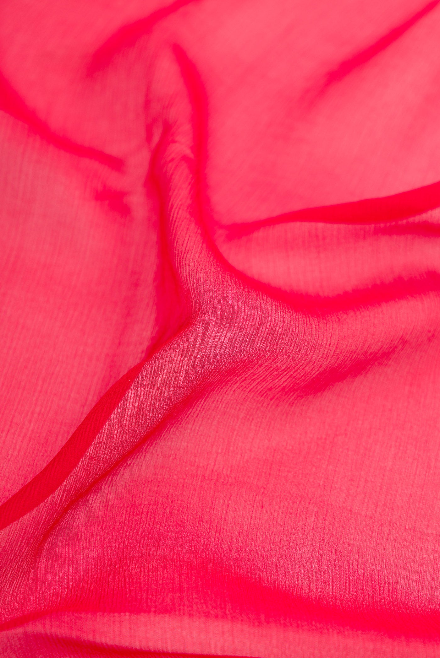 Close up of Red Mysore Chiffon Saree with Plain Body and Zari Border.  displaying folds