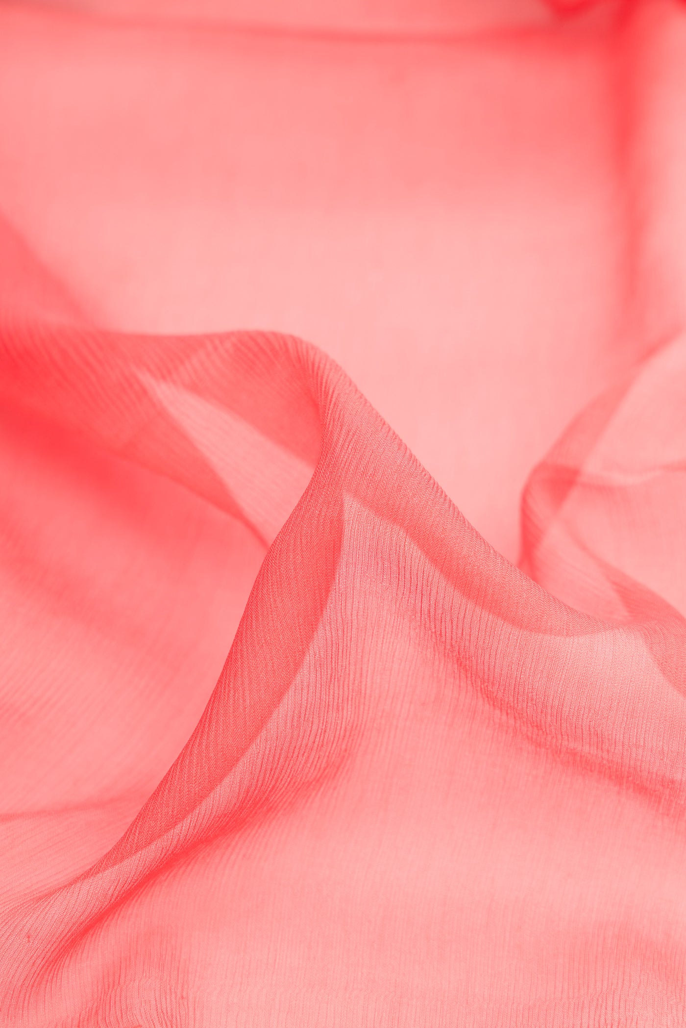 Close up of Peach Mysore Chiffon Saree with Plain Body and Zari Border.  displaying folds