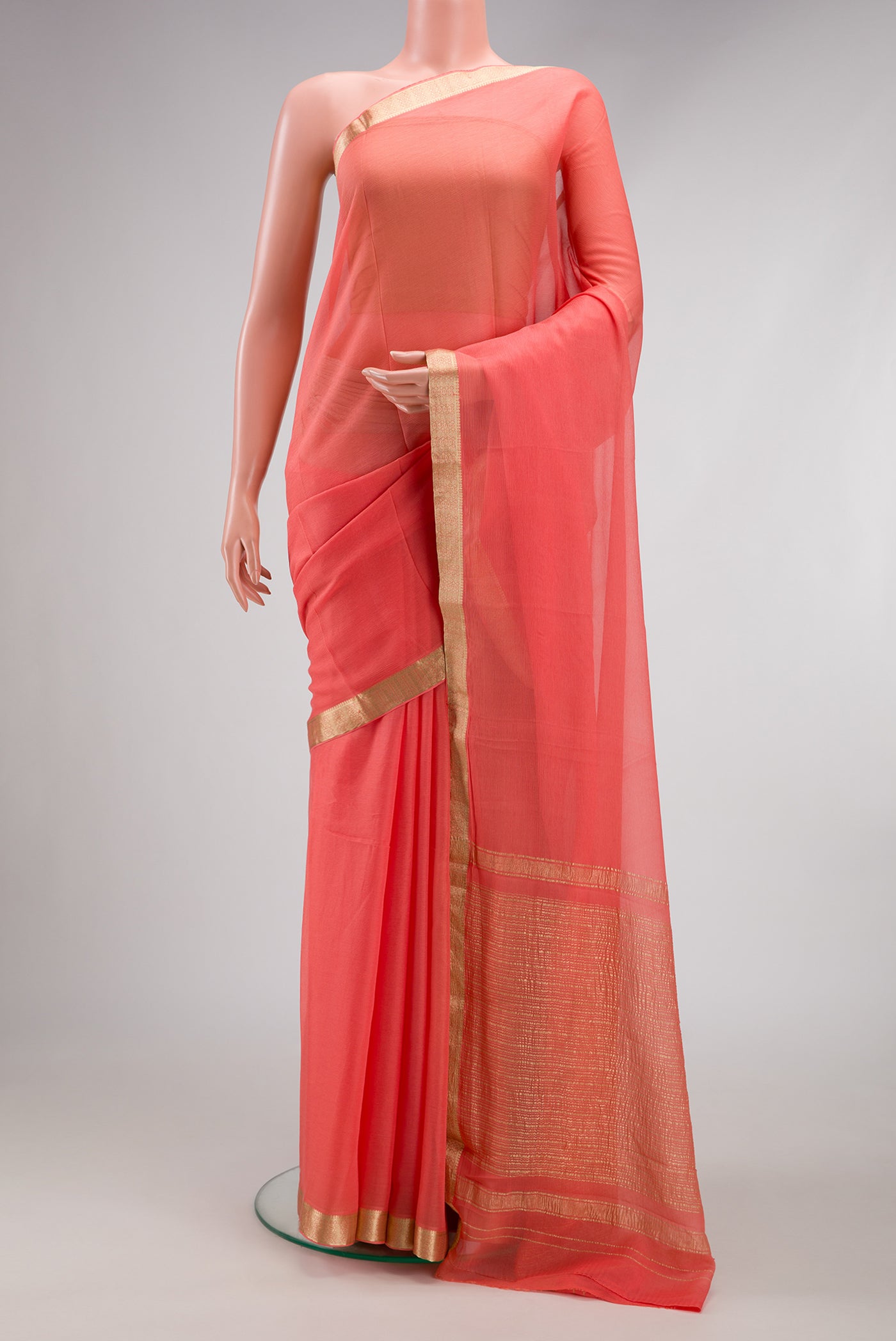 Peach Mysore Chiffon Saree with Plain Body and Zari Border.  displayed on a mannequin