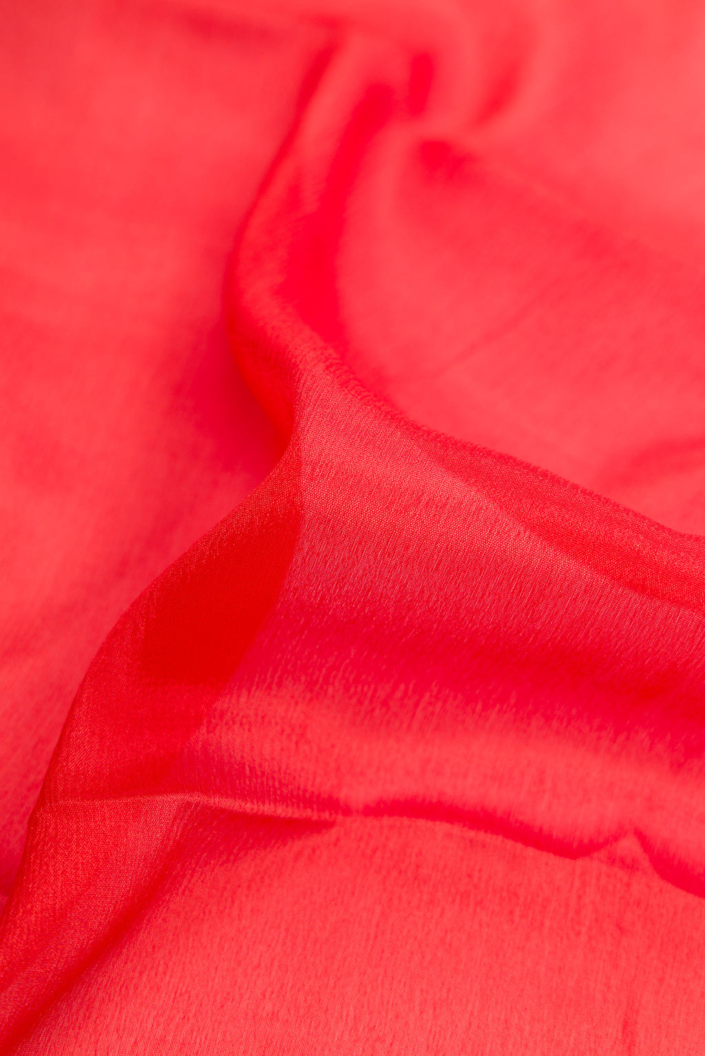 Close up of Brick Orange Dual Tone Mysore Georgette Saree with Plain Body and Zari Border.  displaying folds