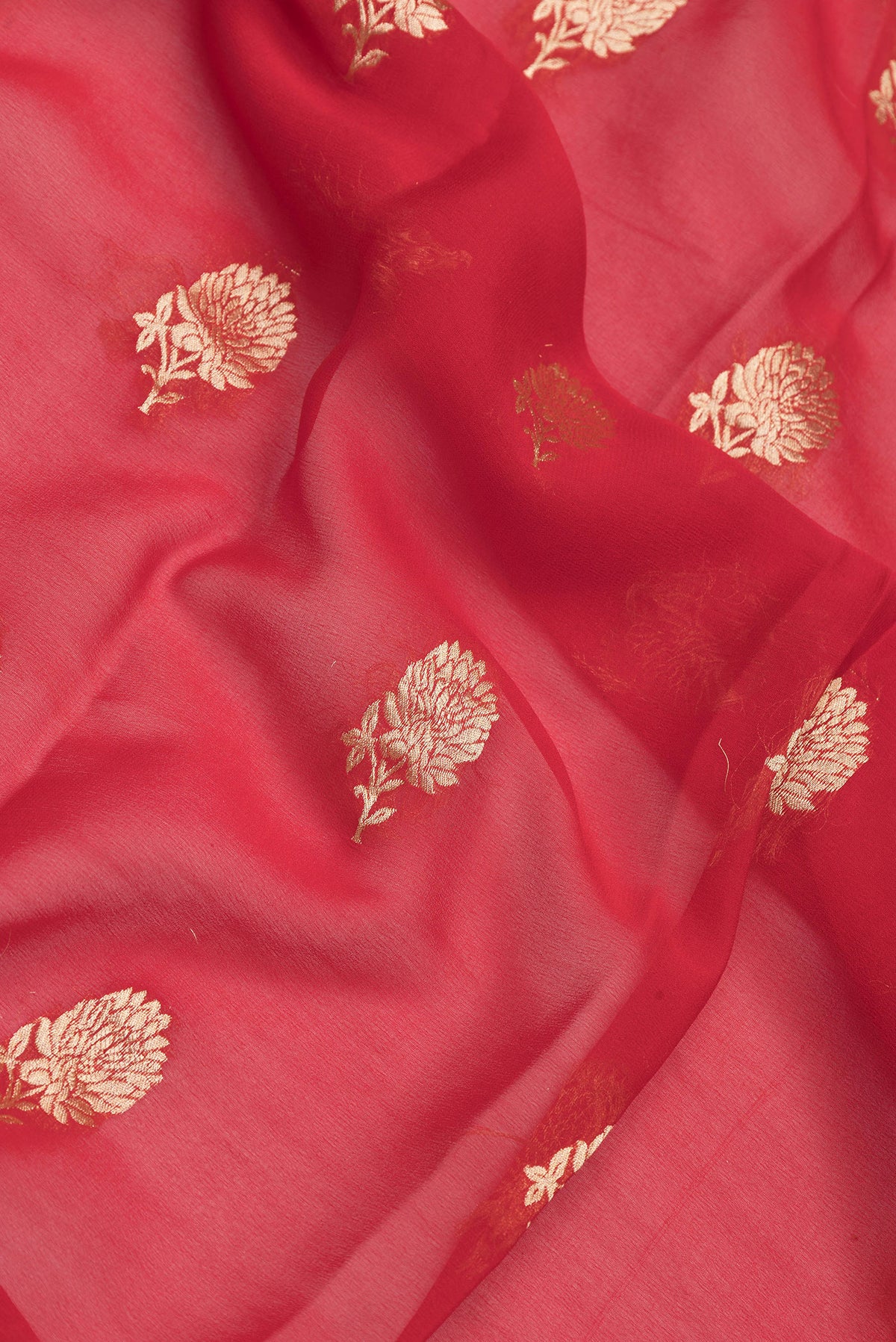 Close up of Red Dual Tone Mysore Georgette Saree with Zari Butta on the body and Zari Border.  displaying folds