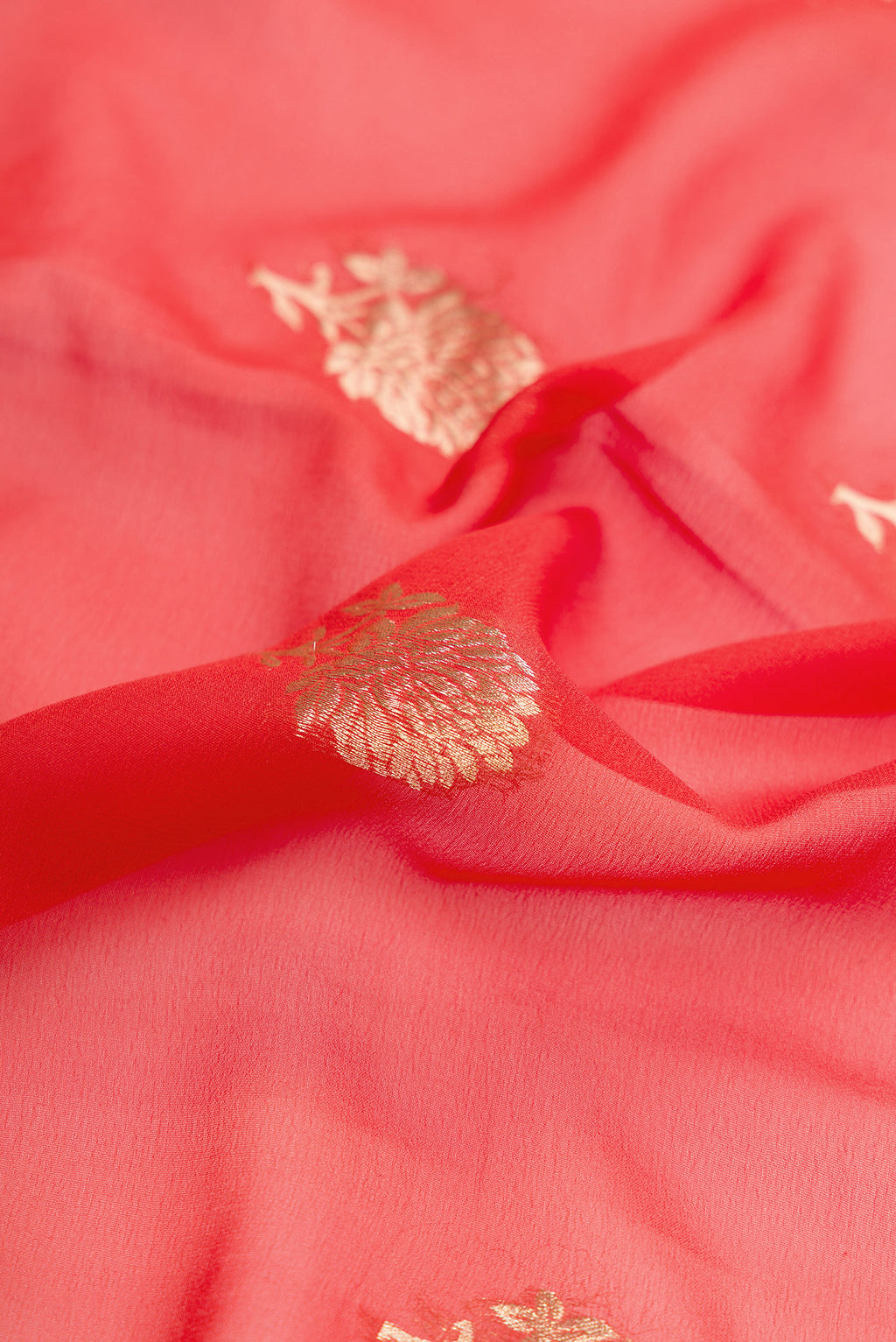 Close up of Brick Orange Dual Tone Mysore Georgette Saree with Zari Butta on the body and Zari Border.  displaying folds