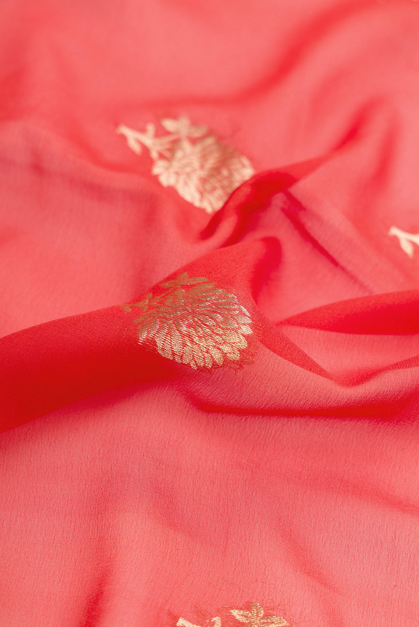 Close up of Brick Orange Dual Tone Mysore Georgette Saree with Zari Butta on the body and Zari Border.  displaying folds