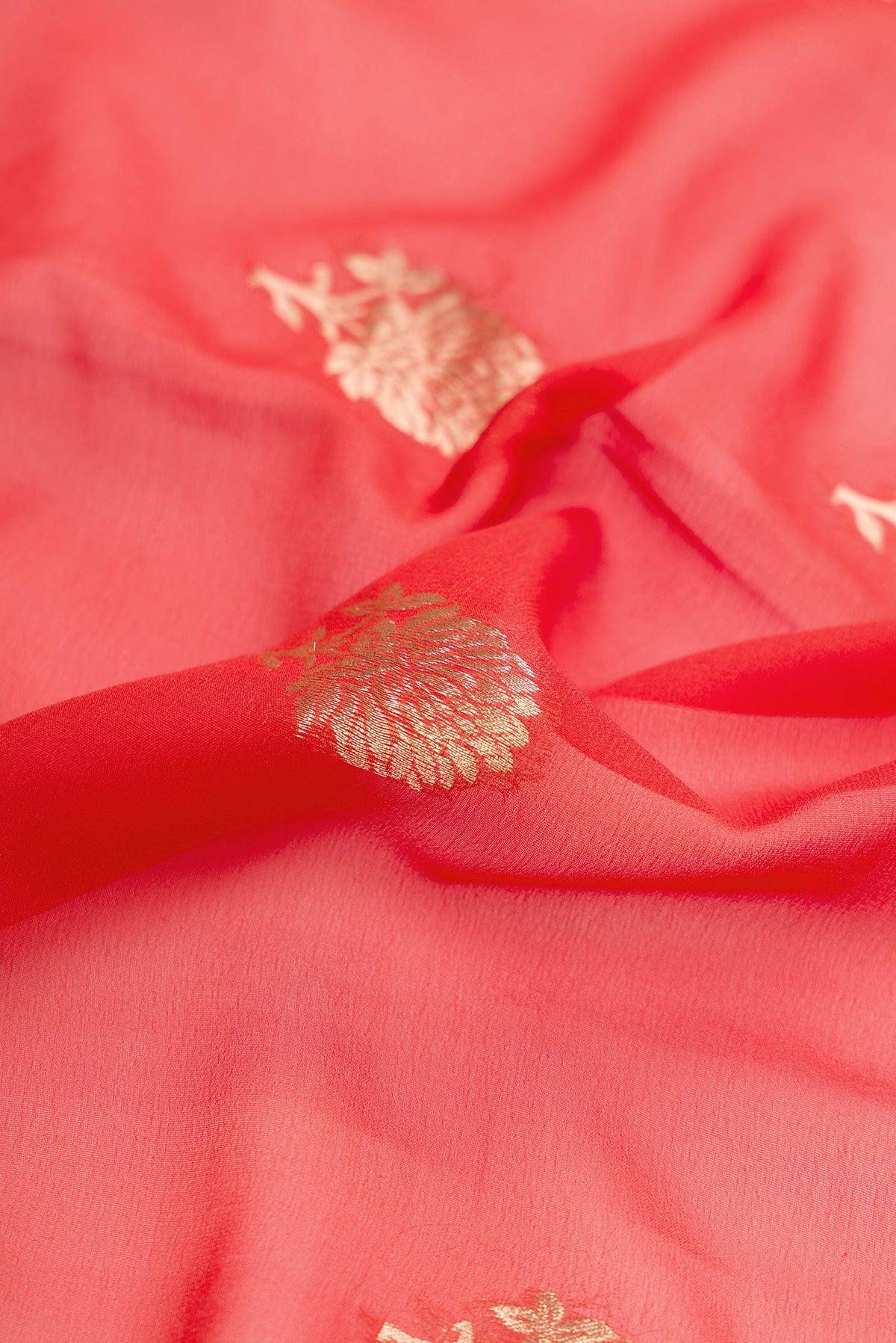 Close up of Brick Orange Dual Tone Mysore Georgette Saree with Zari Butta on the body and Zari Border.  displaying folds